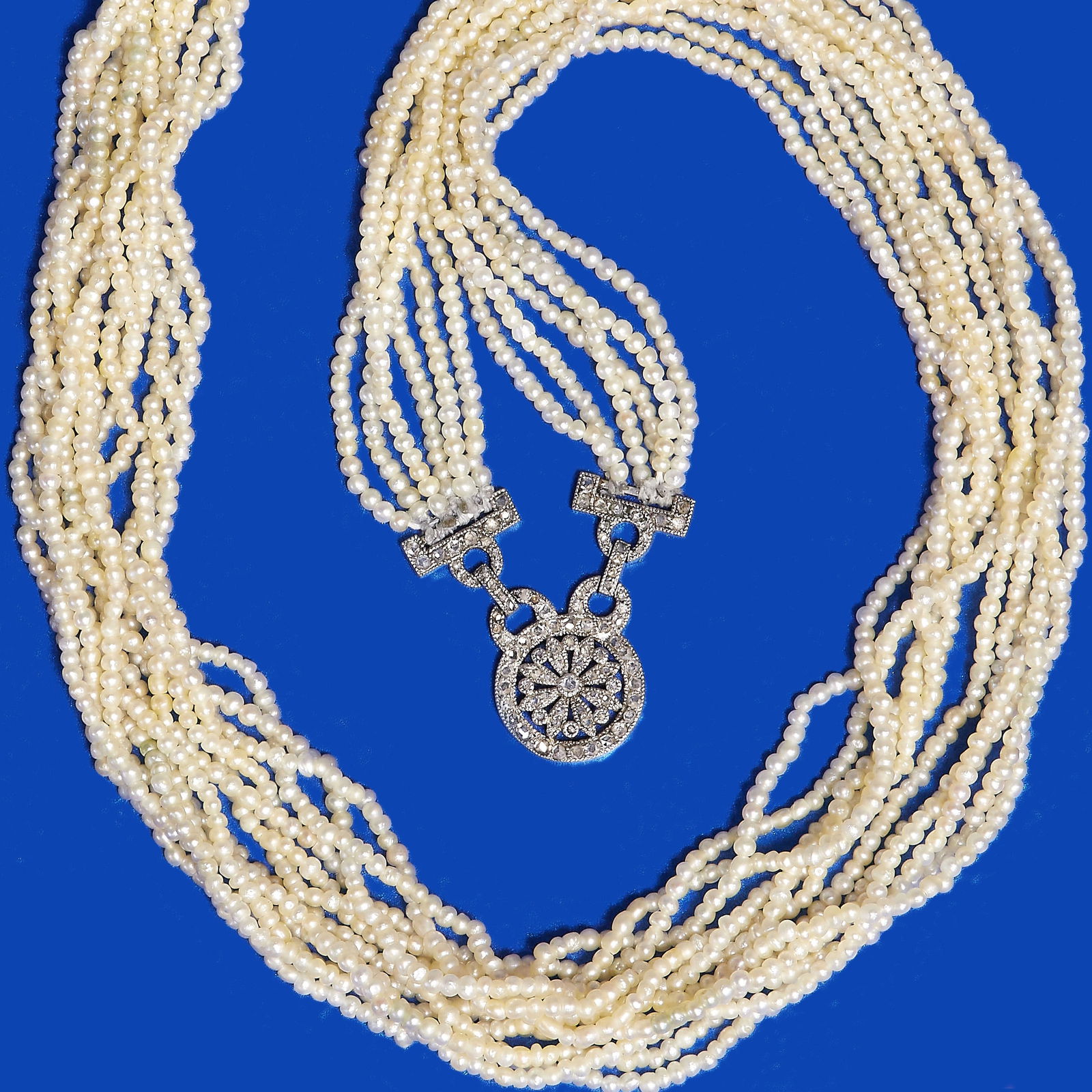 EDWARDIAN MULTI STRAND SEED PEARL AND DIAMOND NECKLACE: EDWARDIAN MULTI STRAND SEED PEARL AND DIAMOND NECKLACE,27.6 grams, testing platinum.Diamonds bright and lively.Fine seed pearls (untested).L. 82 cm.