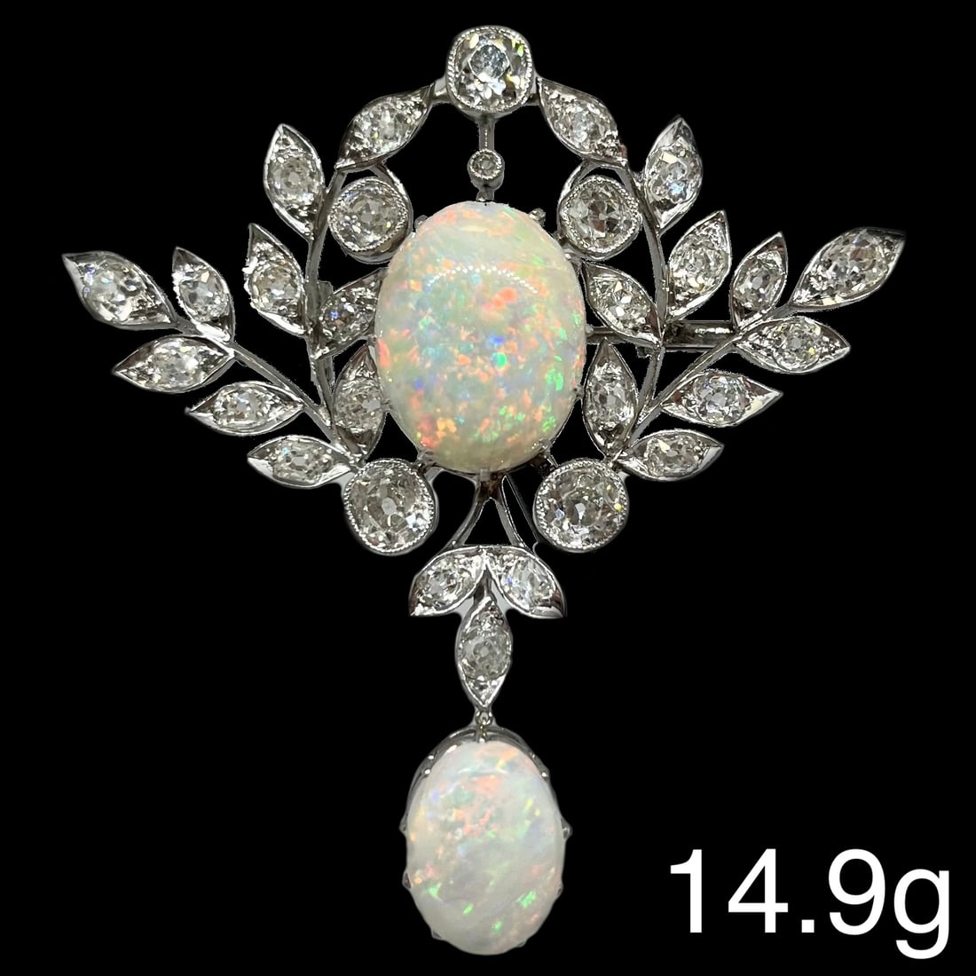 FINE OPAL AND DIAMOND BROOCH: FINE OPAL AND DIAMOND BROOCH,14,9 grams, testing high carat gold.Bright and lively old cut diamonds, totalling approx. 4.50 ct. Rich and vibrant opals with good play of colour inclusing reds, totallin