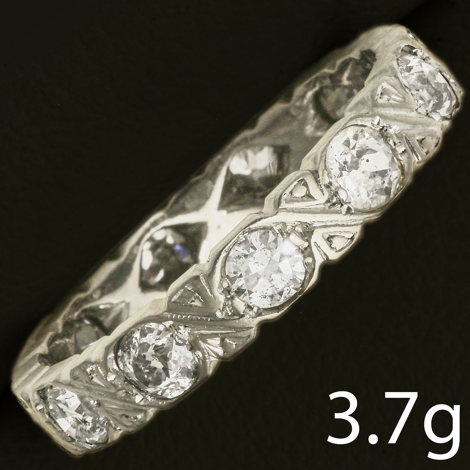 DIAMOND ETERNITY RING: DIAMOND ETERNITY RING,3.7 grams, testing high carat gold.Diamonds bright and lively, totalling approx. 1.20 ct.Size N.