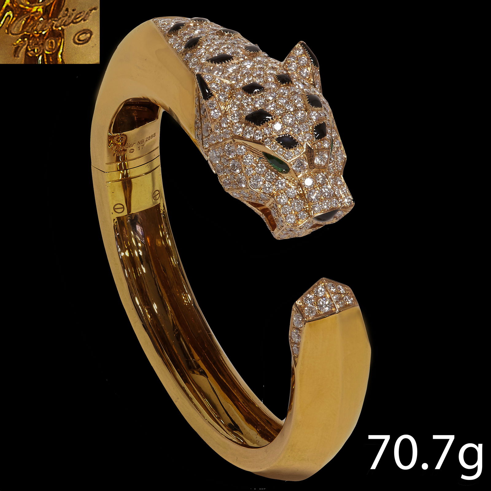 VERY FINE ONYX AND DIAMOND PANTHER BANGLE, IN THE STYLE OF CARTIER: VERY FINE ONYX AND DIAMOND PANTHER BANGLE, IN THE STYLE OF CARTIER.70.7 grams, 18 ct. gold Beautifully made, in excellent condition with bright lively diamond.5.7 cm diameter PLEASE NOTE- WE ARE NOT S