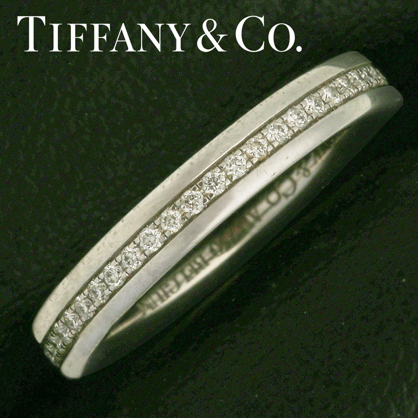 TIFFANY & CO., DIAMOND ETERNITY RING: TIFFANY & CO., DIAMOND ETERNITY RING2.6 grams, marked 18 carat gold. Bright and lively diamonds. Quality craftsmanship. Size K 1/2. In Tiffany & Co. box and outer box.