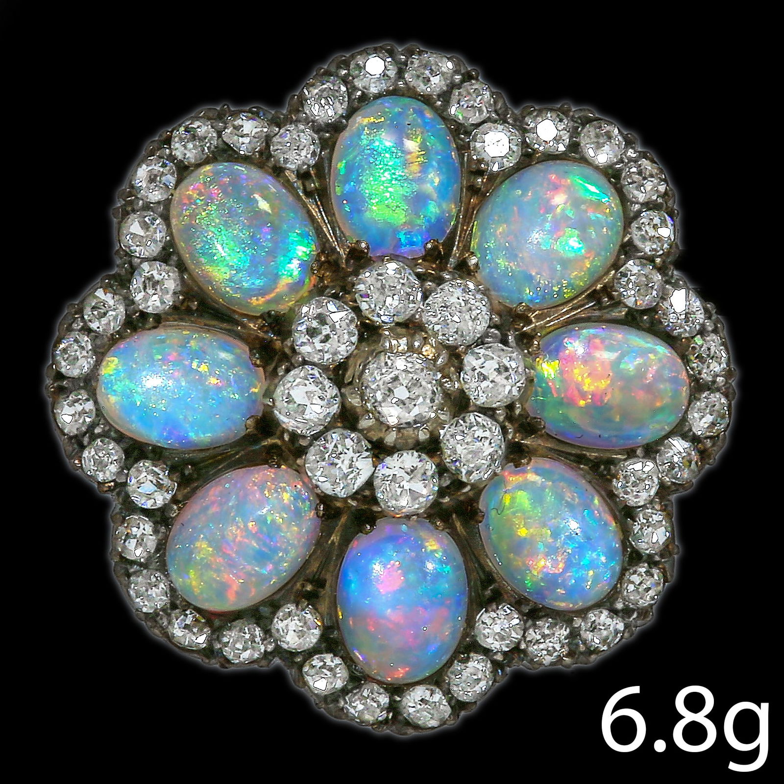 VICTORIAN OPAL AND DIAMOND BROOCH: VICTORIAN OPAL AND DIAMOND BROOCH,6.8 grams.Vibrant opal with good play of colour including reds.Diamonds bright and lively.Diam. 2.6 cm.
