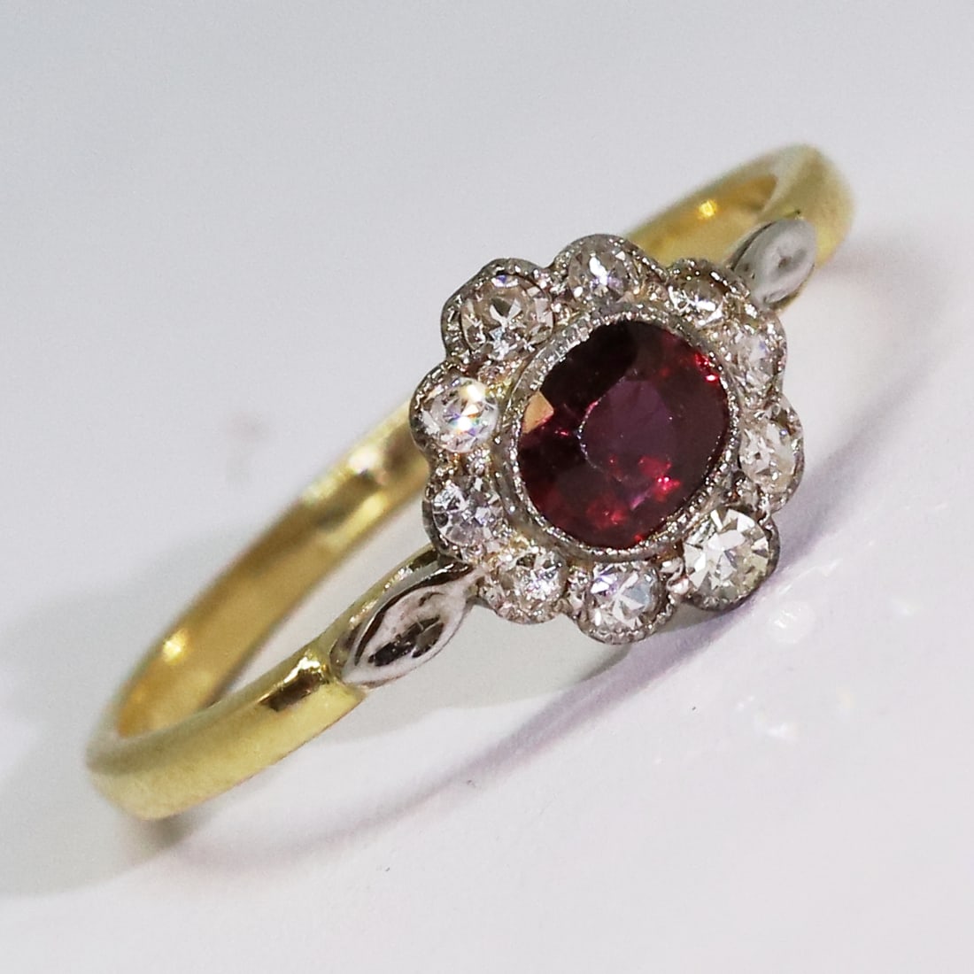 RUBY AND DIAMOND CLUSTER RING: RUBY AND DIAMOND CLUSTER RING,testing high carat gold.Rich and vibrant ruby.Diamonds bright and lively.Size M 1/2.