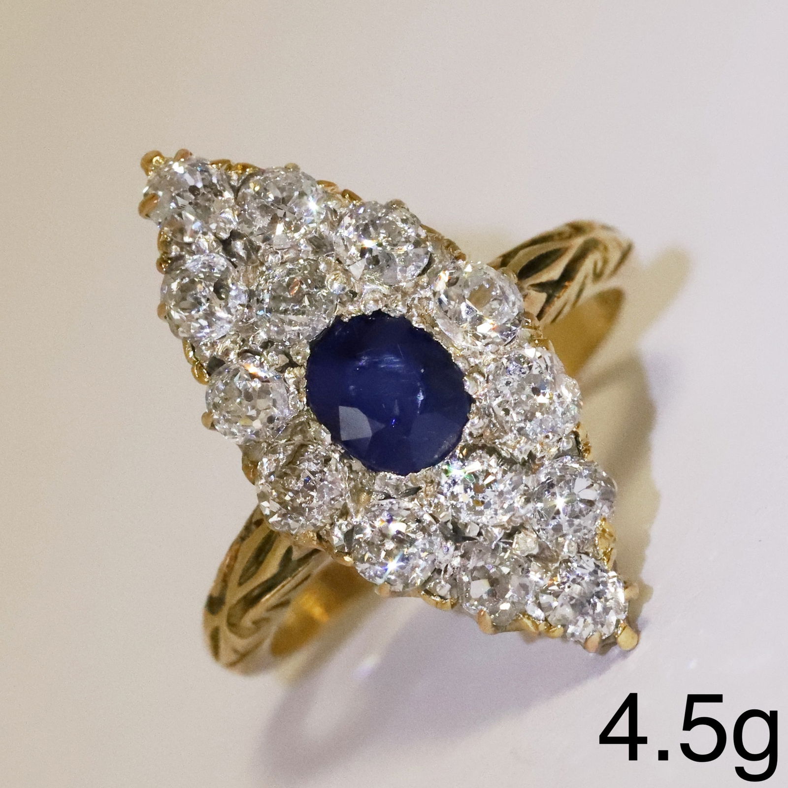 SAPPHIRE AND DIAMOND NAVETTE SHAPED RING: SAPPHIRE AND DIAMOND NAVETTE SHAPED RING,4,5 grams, testing high carat gold.Rich and vibrant sapphire of approx. 1.12 ct.Bright and lively old cut diamonds, totalling approx. 1.40 ct.L. head 2.3
