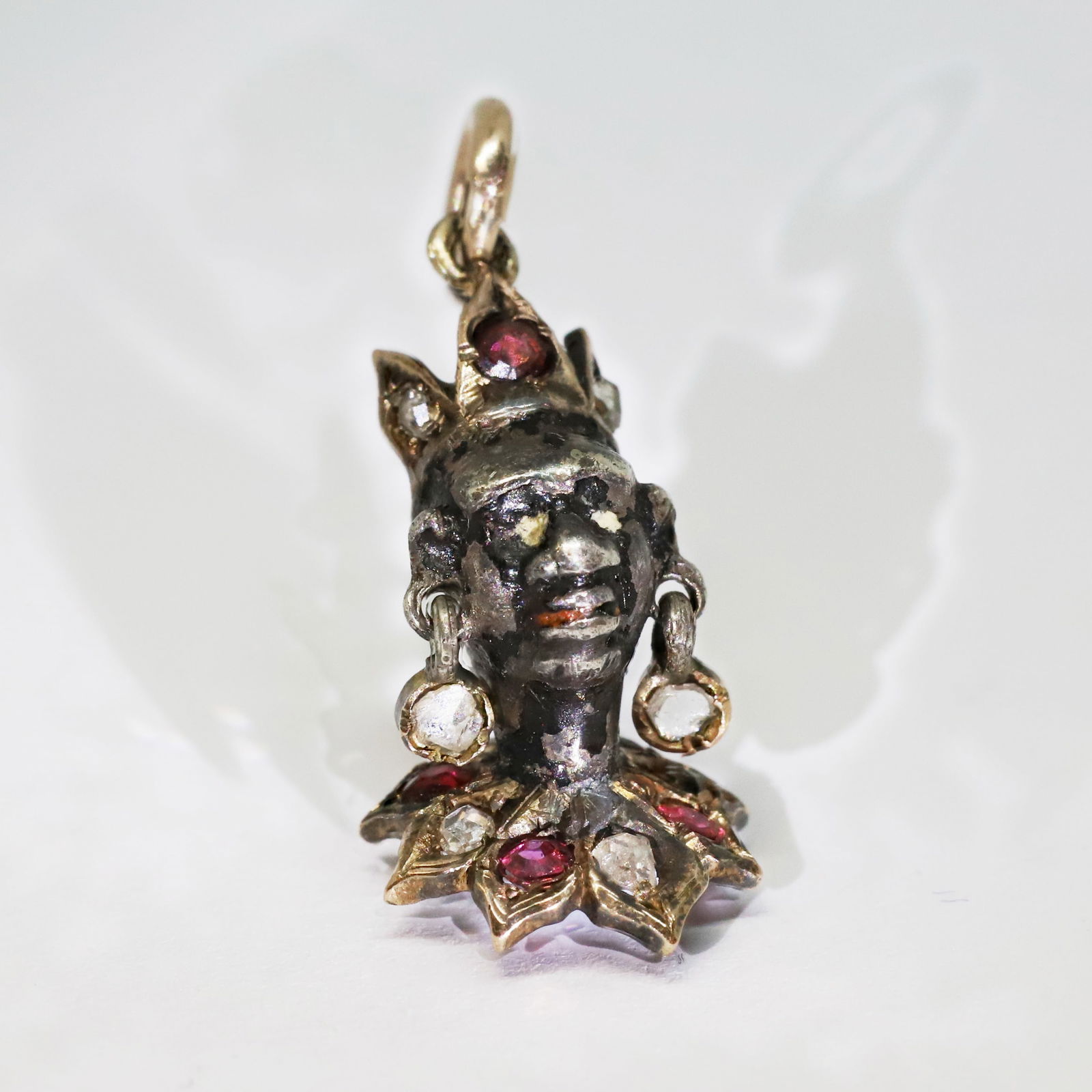 RARE AND UNUSUAL ANTIQUE RUBY AND DIAMOND BLACKAMOOR PENDANT: RARE AND UNUSUAL ANTIQUE RUBY AND DIAMOND BLACKAMOOR PENDANT,3.2 gams. High carat gold.The collar and crown set with rubies and diamonds.L. 2.7 cm.