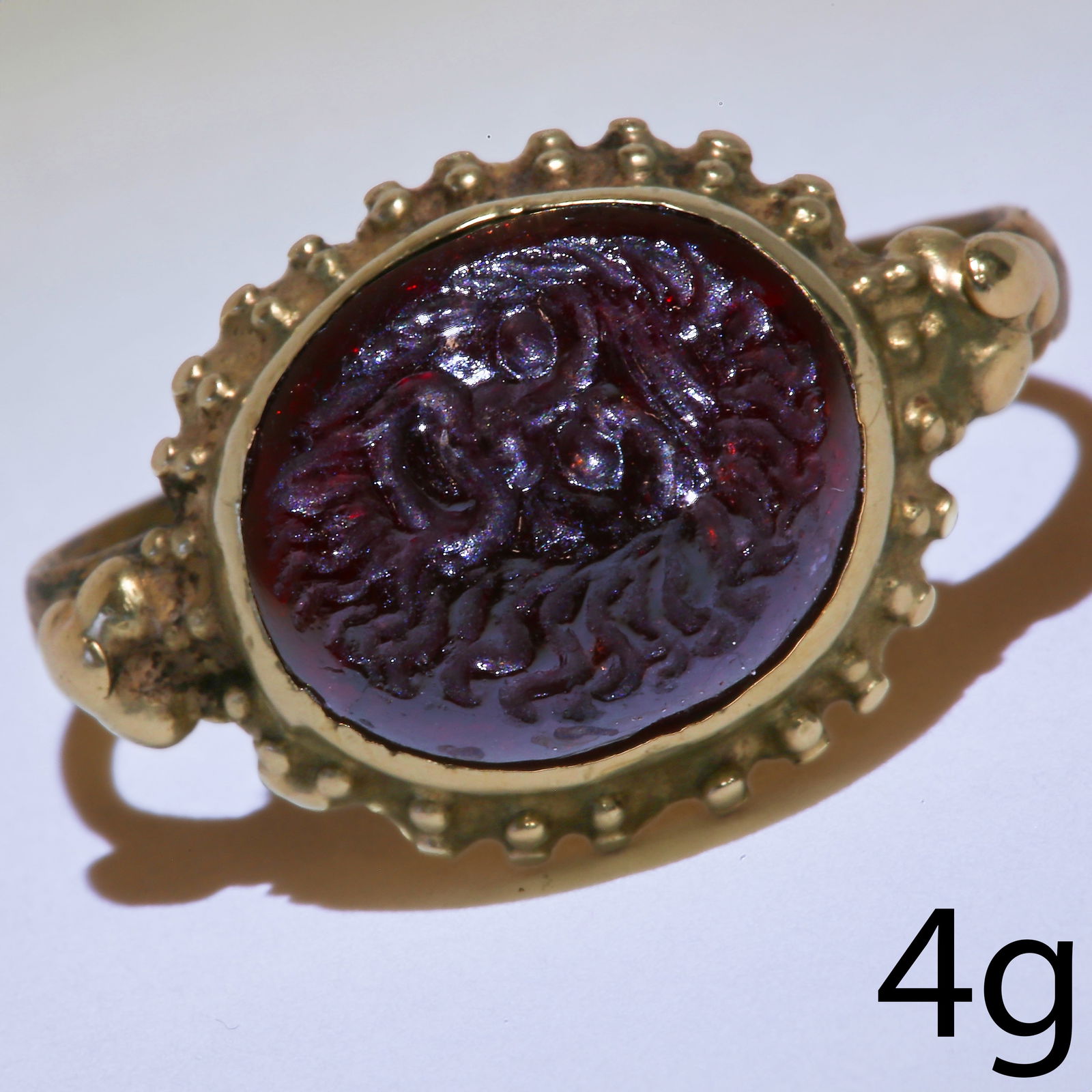 ANCIENT GARNET INTAGLIO 3RD CENTURY ROMAN SASSANIAN, RING.: ANCIENT GARNET INTAGLIO 3RD CENTURY ROMAN SASSANIAN, RING.Detailed carved garnet intaglio depicting a bearded man.Later mounted into a ring.Size M.