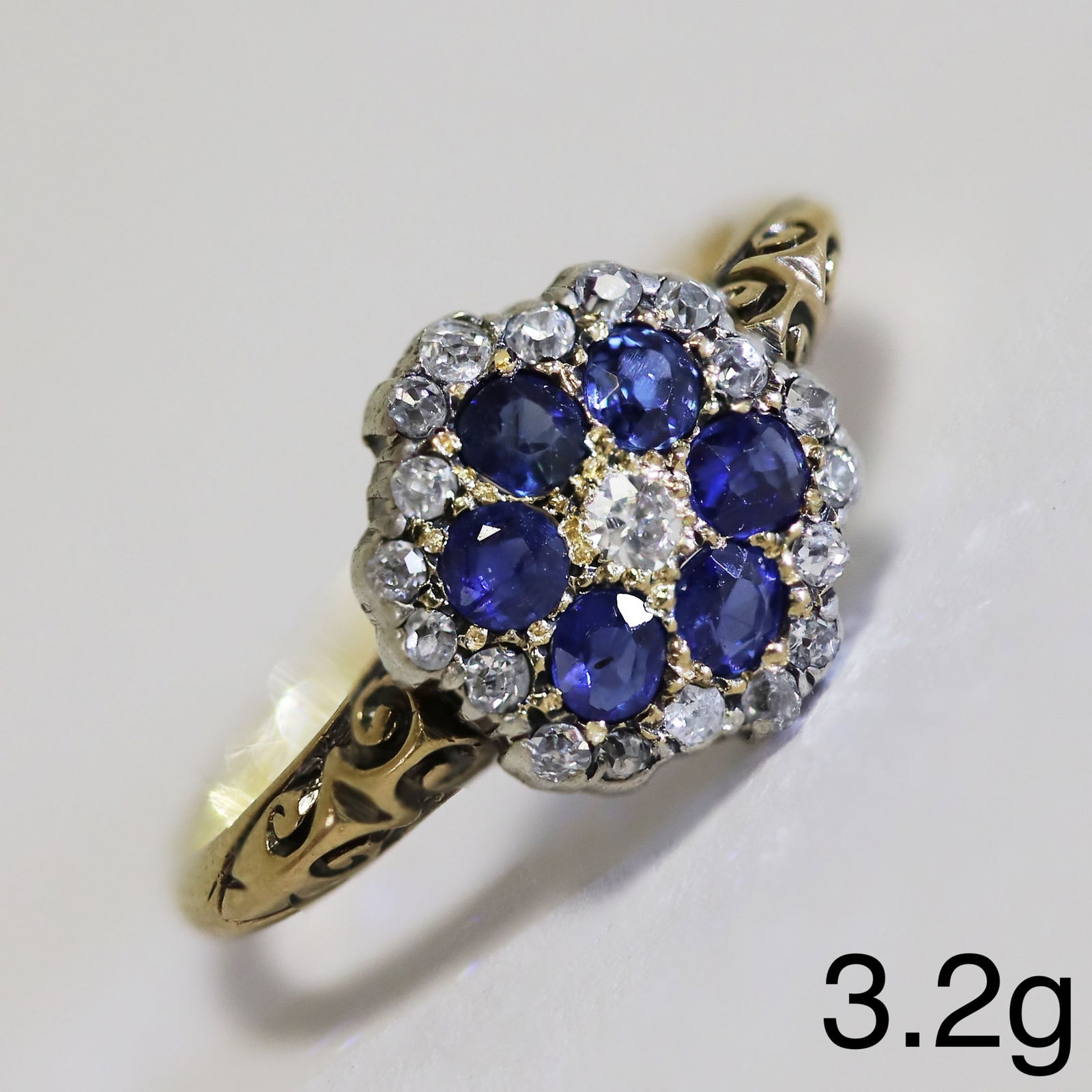 SAPPHIRE AND DIAMOND CLUSTER RING: SAPPHIRE AND DIAMOND CLUSTER RING,3.2 grams, testing 18 ct. gold.Rich and vibrant sapphires.Diamonds bright and lively.Size O