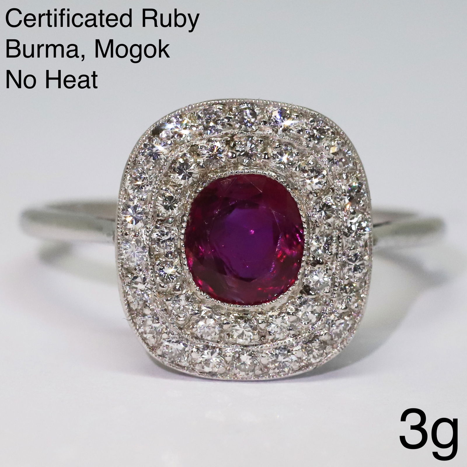 FINE CERTIFICATED BURMA NO HEAT RUBY AND DIAMOND CLUSTER RING: FINE CERTIFICATED BURMA NO HEAT RUBY AND DIAMOND CLUSTER RING,Testing high carat gold.Rich and vibrant ruby of 1.03 ct. (Certificated, Burma 'Mogok', No Heat).Diamonds bright and lively.Size O