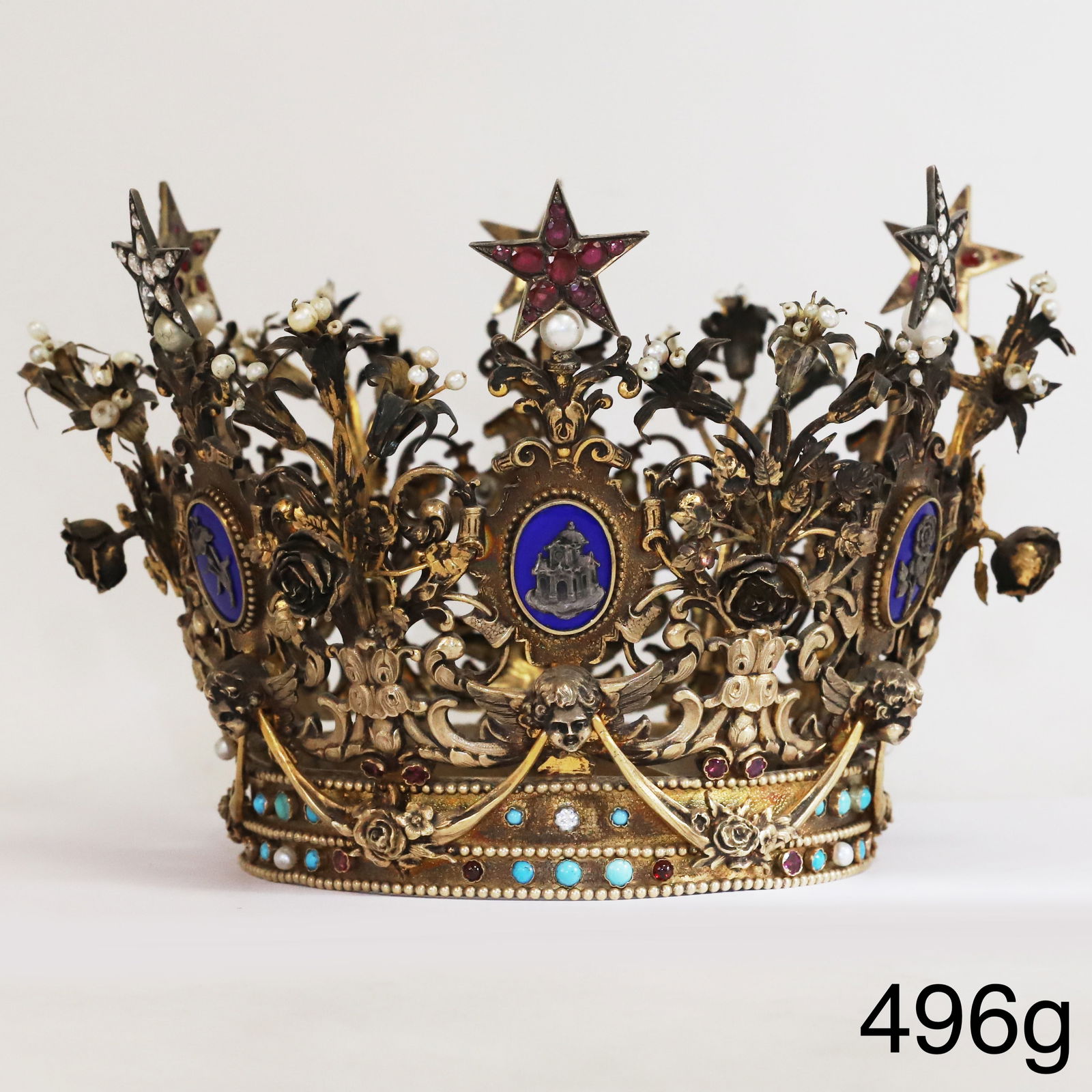 FINE AND RARE ANTIQUE RUBY DIAMOND AND GEMSET CROWN: FINE AND RARE ANTIQUE RUBY DIAMOND AND GEMSET CROWN,496 grams.The crown of abundance relief design, featuring floral designs and segmented shields.The flower at the top accentuated with pearls