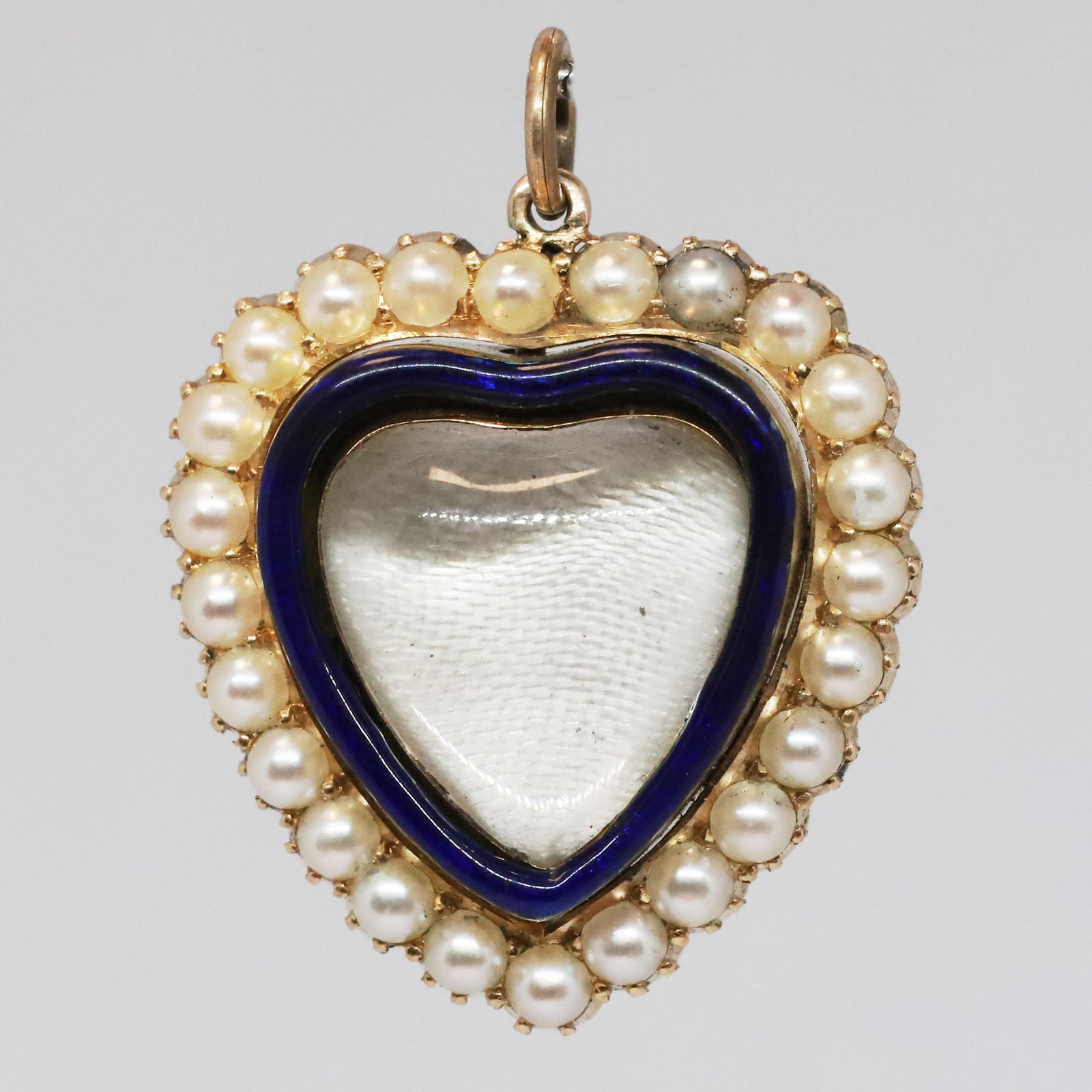 VICTORIAN ROCK CRYSTAL, ENAMEL AND PEARL HEART LOCKET PENDANT: VICTORIAN ROCK CRYSTAL, ENAMEL AND PEARL HEART LOCKET PENDANT,7.8 grams, testing high carat gold.Lovely carved rock crystal.Vibrant enamel in good conditionLovely pearls, untested, assumed to be natur