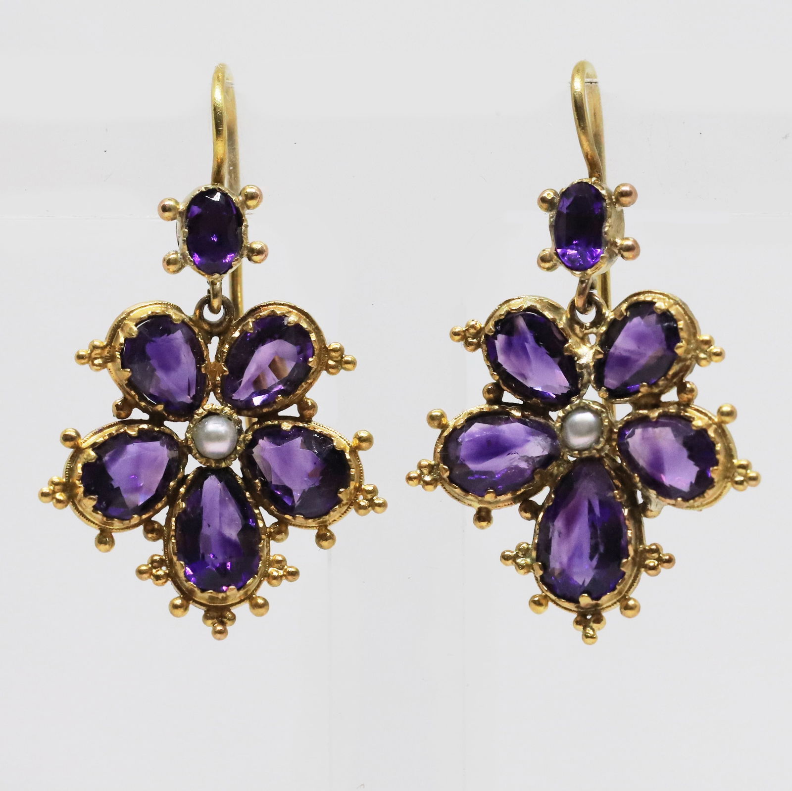 ANTIQUE AMETHYST AND PEARL FLORAL EARRINGS: ANTIQUE AMETHYST AND PEARL FLORAL EARRINGS 4.2 grams high cart gold rich vibrant amethysts matching pearls L 3.3 cm