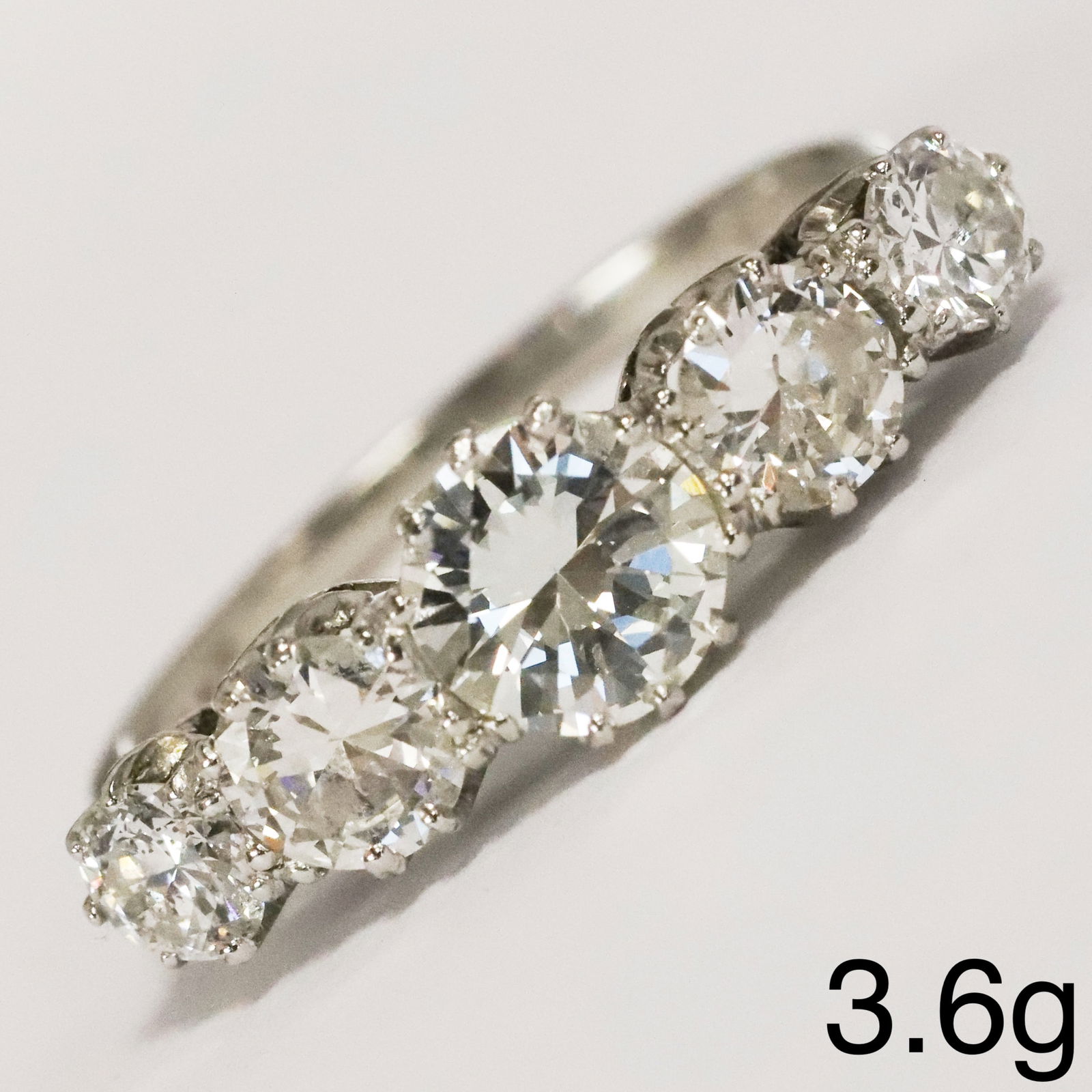 5-STONE DIAMOND RING: 5-STONE DIAMOND RING,3.6 grams, testing platinum.Diamonds bright and lively, totalling approx. 1.85 ct.Size M.