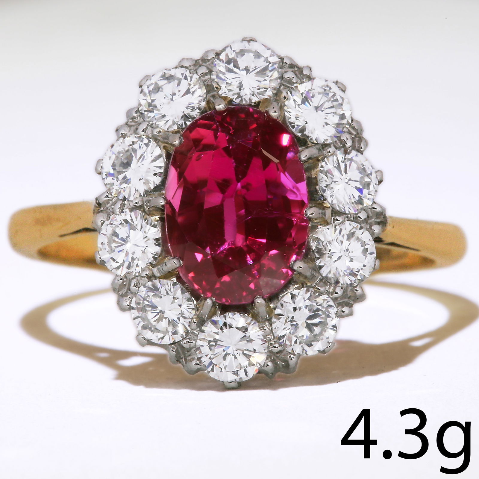 RUBY AND DIAMOND CLUSTER RING: RUBY AND DIAMOND CLUSTER RING,4.3 grams, 18 ct. gold and platinum.Gemstones totalling approx. 3.42 ct.Vibrant ruby of approx. 2.42 ct.Diamonds bright and lively.Size O 1/2.
