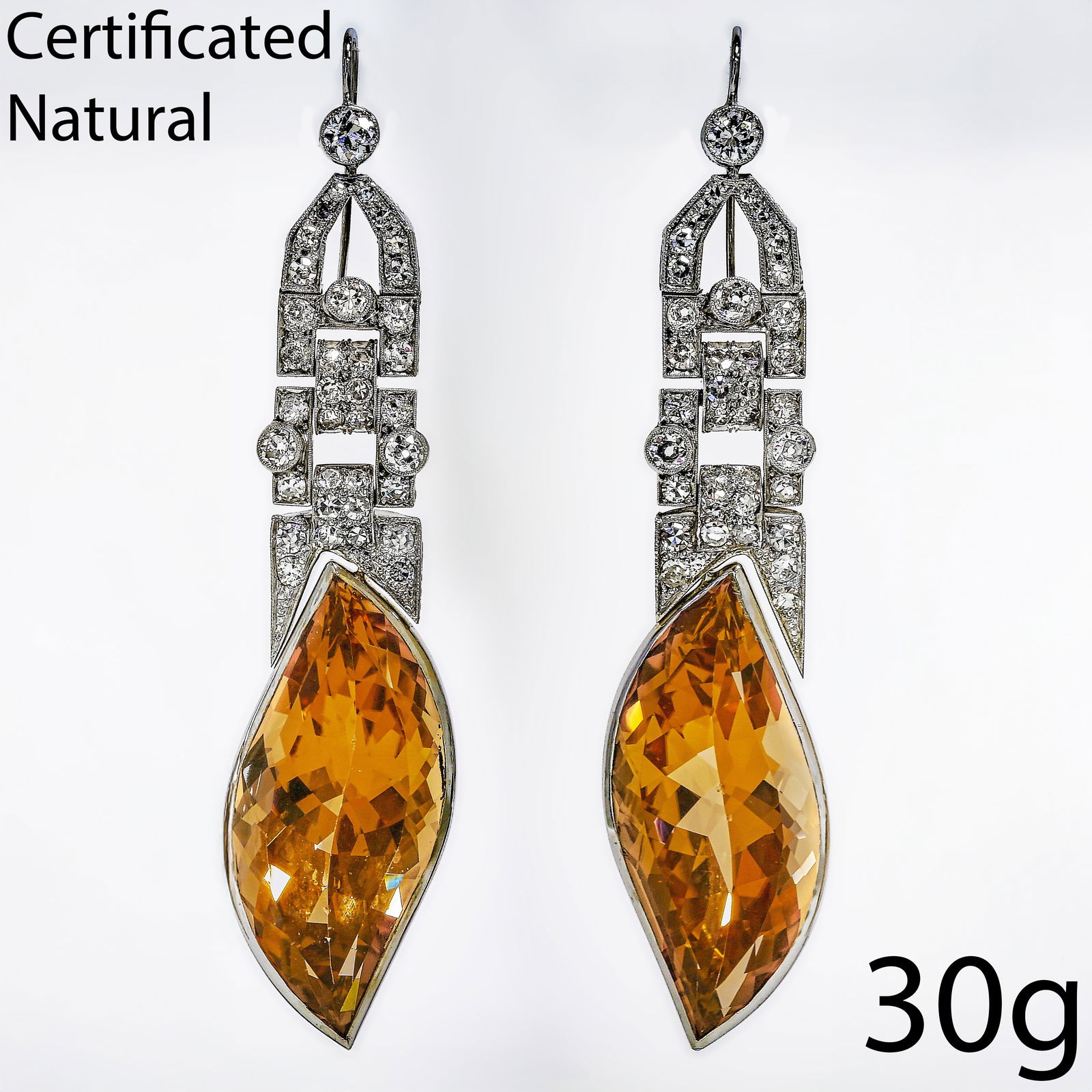 FANTASTIC PAIR OF CERTIFICATED TOPAZ AND DIAMOND EARRINGS: FANTASTIC PAIR OF CERTIFICATED TOPAZ AND DIAMOND EARRINGS,30 grams, testing platinum.Each earrings with a large topaz drop of approx. 39.57 and 39.15 ct.Diamonds bright and lively.L. 7.6 cm.See