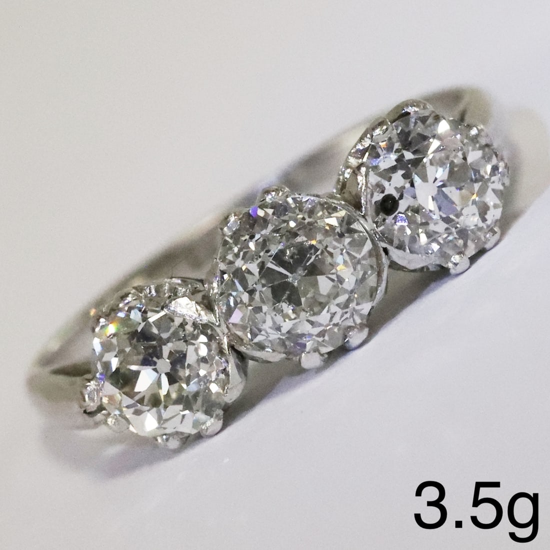 EDWARDIAN DIAMOND 3-STONE RING: EDWARDIAN DIAMOND 3-STONE RING,3,5 grams, platinum.Bright and lively old cut diamond of approx. 0.82 ct. 0.68 ct. and .060 ct. totalling approx. 2.10 ct.Size N 1/2.