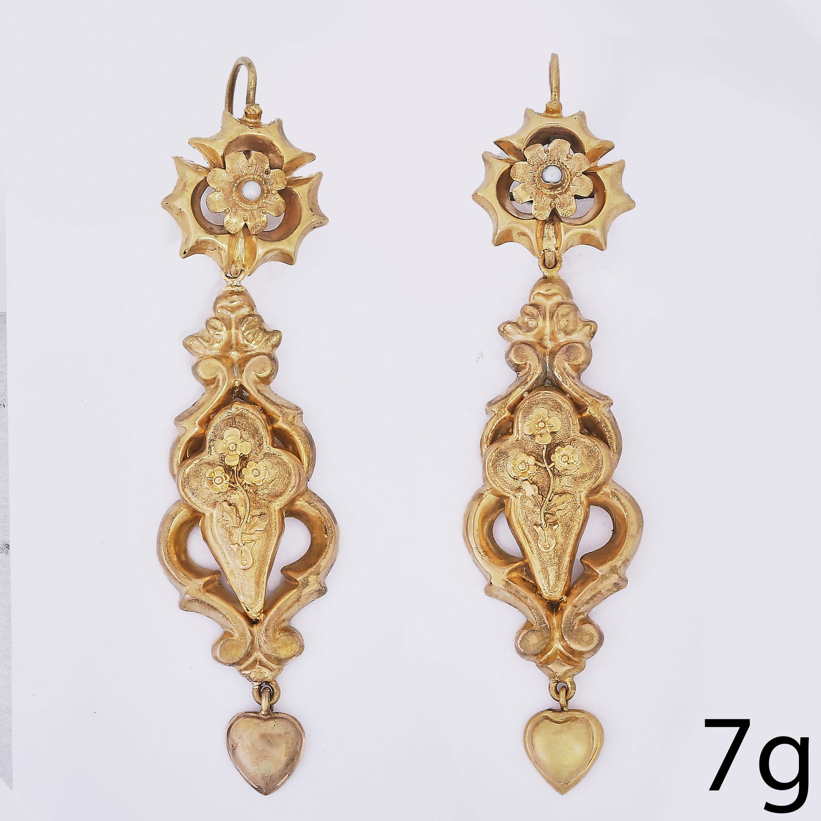 PAIR OF GEORGIAN GOLD AND PEARL EARRINGS: PAIR OF GEORGIAN GOLD AND PEARL EARRINGS12.3 grams, testing high carat gold. With scrolling foliate detail and heart-shaped drops.Hook fittings. Pearls to surmounts untested, assumed to be natural.