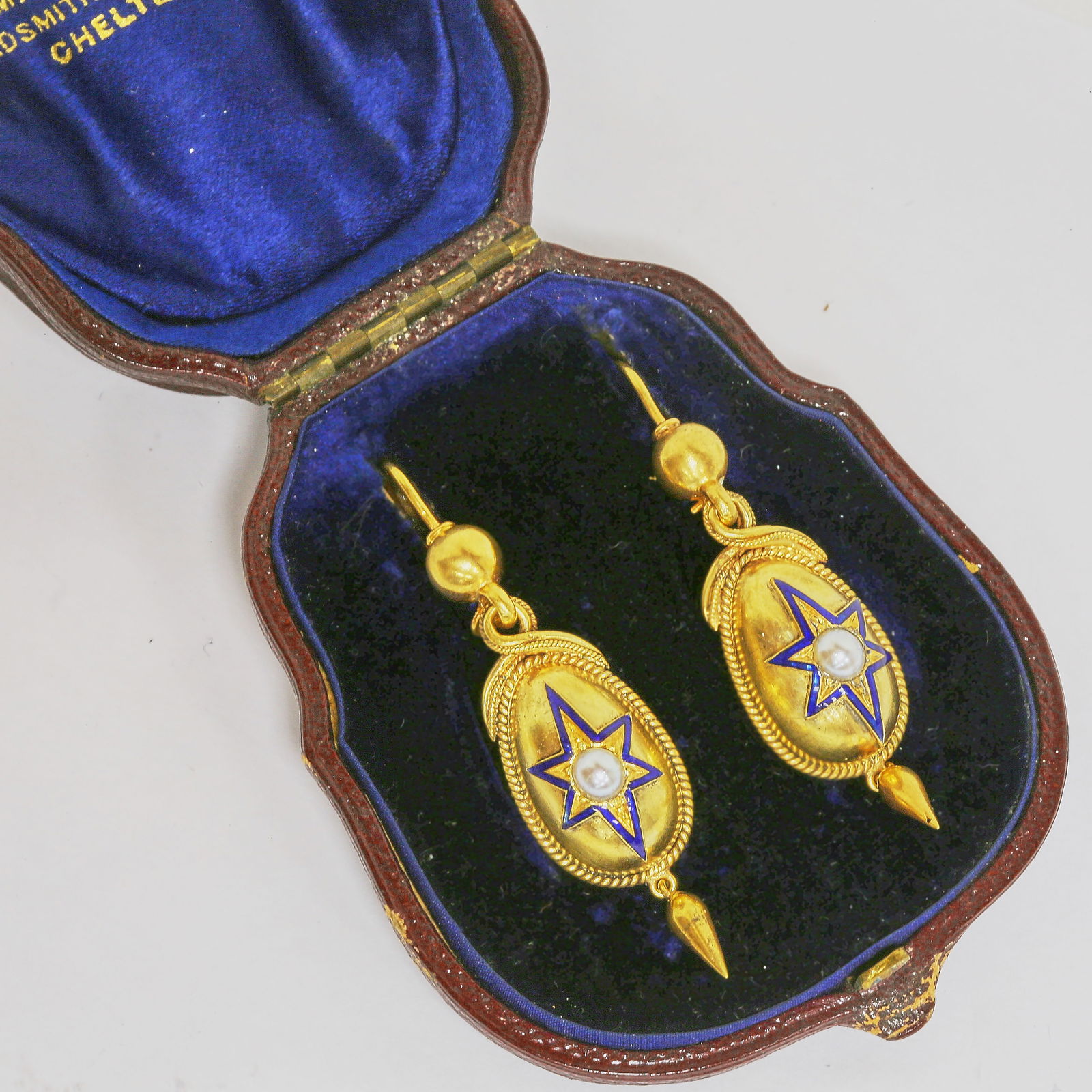PAIR OF VICTORIAN ENAMEL AND PEARL EARRINGS: PAIR OF VICTORIAN ENAMEL AND PEARL EARRINGS,9.5 grams, testing high carat gold.Lovely blue enamel in star pattern, surrounding the central pearl.Articulated drop.L. 5.5 cm.With antique earring box.