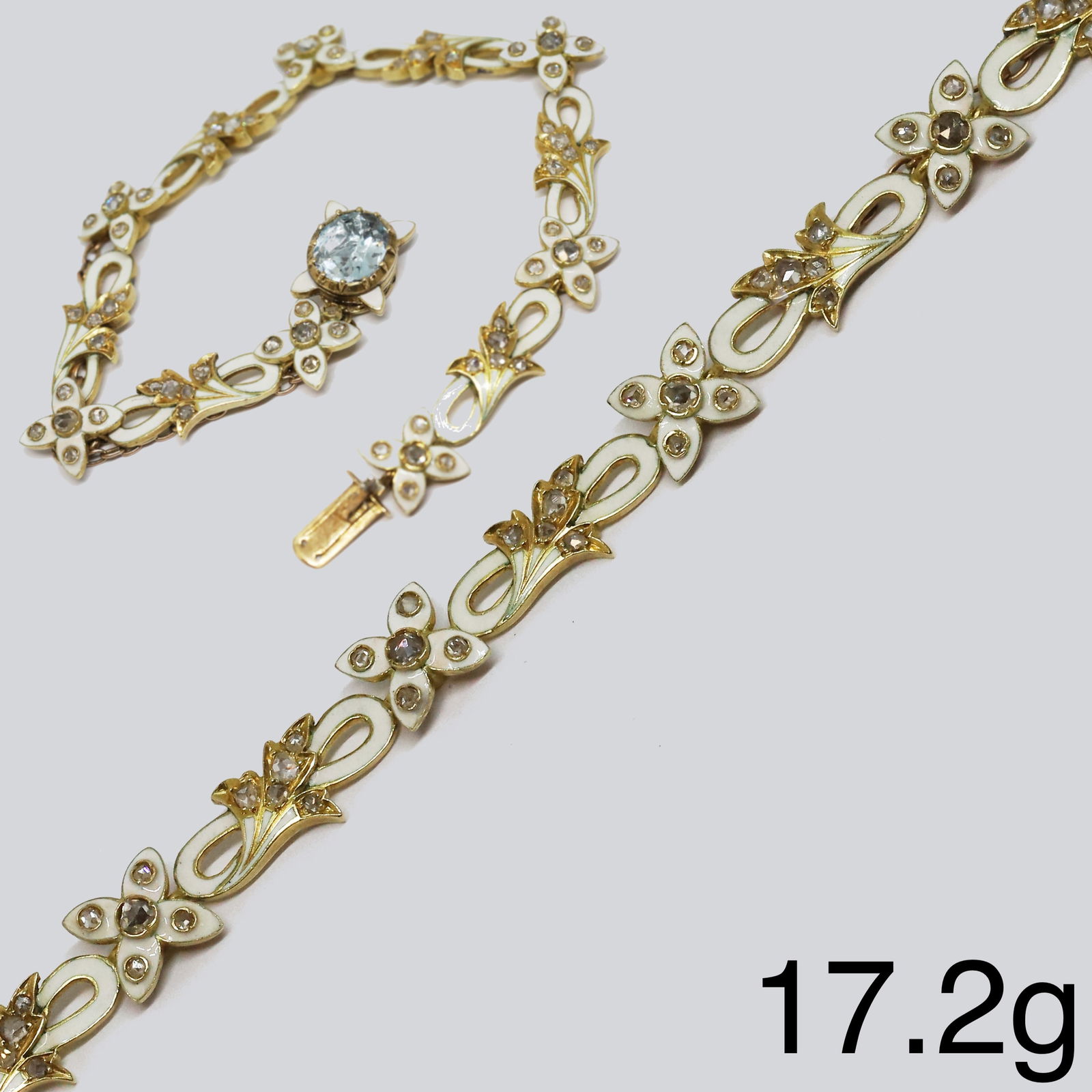 RARE ANTIQUE AQUAMARINE DIAMOND AND ENAMEL BRACELET: RARE ANTIQUE AQUAMARINE DIAMOND AND ENAMEL BRACELET17.1 grams, testing high carat gold. The clasp set with a rich and vibrant aquamarine. The links of entwined part floral design, accentuated with bri
