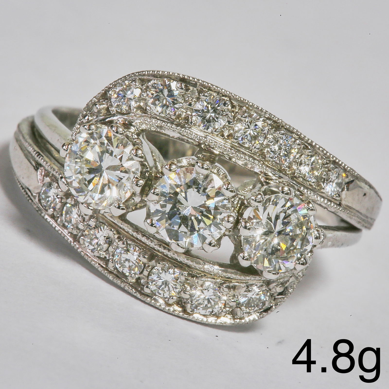 DIAMOND TWIST RING: DIAMOND TWIST RING,4,8 grams, testing high carat gold.Diamonds bright and lively, totalling approx. 1.35 ct.Size M 1/2.