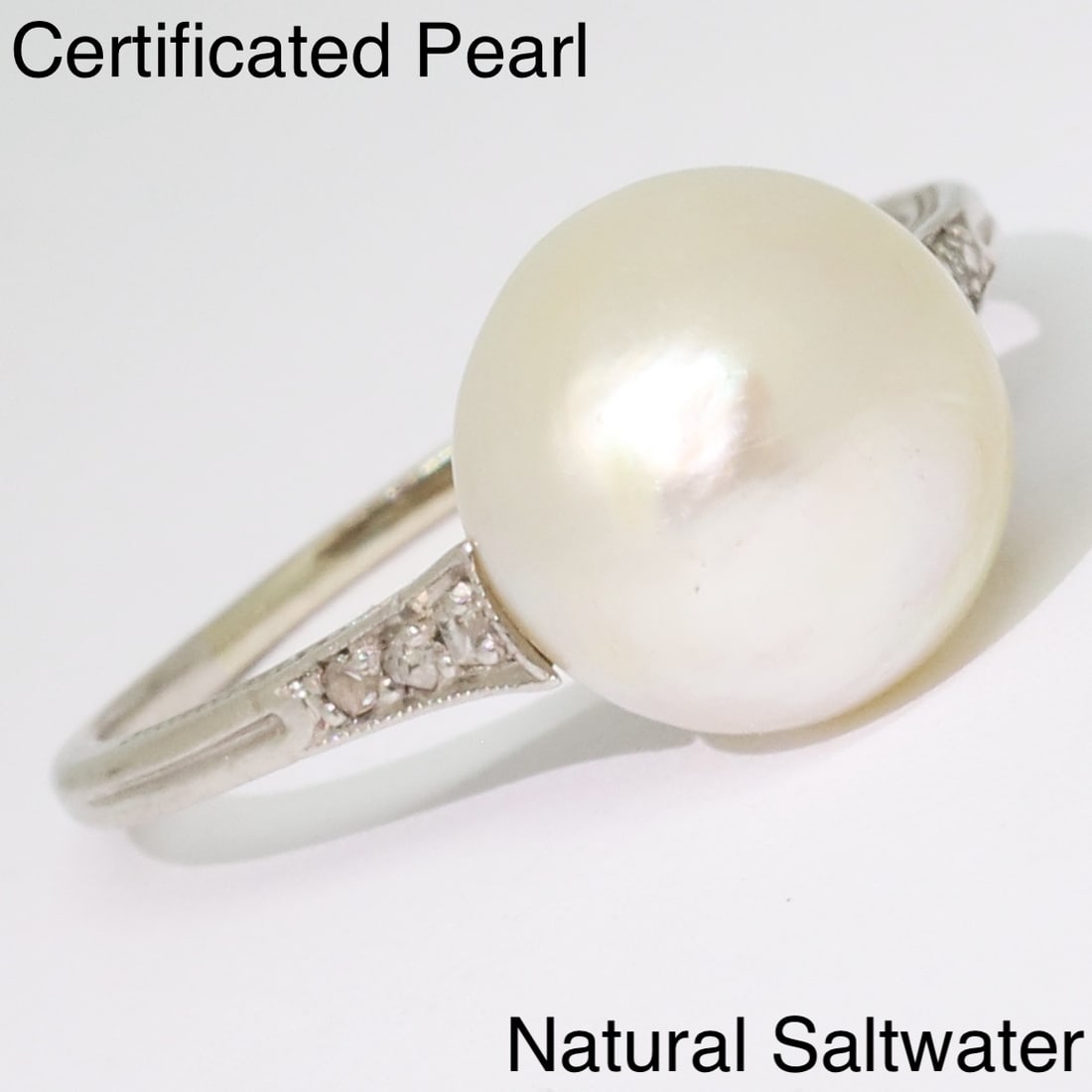 CERTIFICATED NATURAL SALTWATER PEARL AND DIAMOND RING: CERTIFICATED NATURAL SALTWATER PEARL AND DIAMOND RING,testing platinum.The pearl of approx. 9.8 x 9.7 x 7.6 mm. (Certificated, Natural, Saltwater).Lovely diamonds on the shoulders.Size L 1/2.See certi