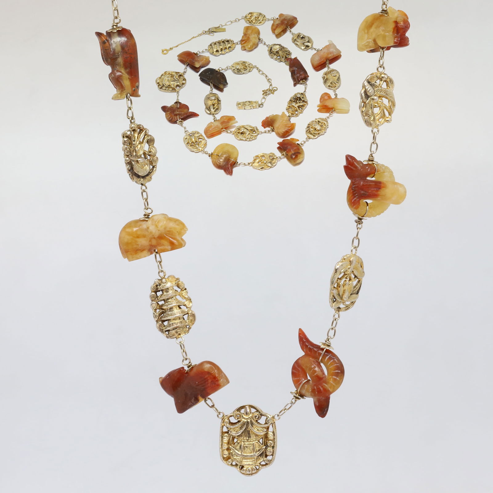 UNUSUAL ANTIQUE CARVED JADE NECKLACE: UNUSUAL ANTIQUE CARVED JADE NECKLACE,70.3 grams.With 12 carved jade animals, depicting the zodiac signs.Alternated with relief plaques.L. 74.5