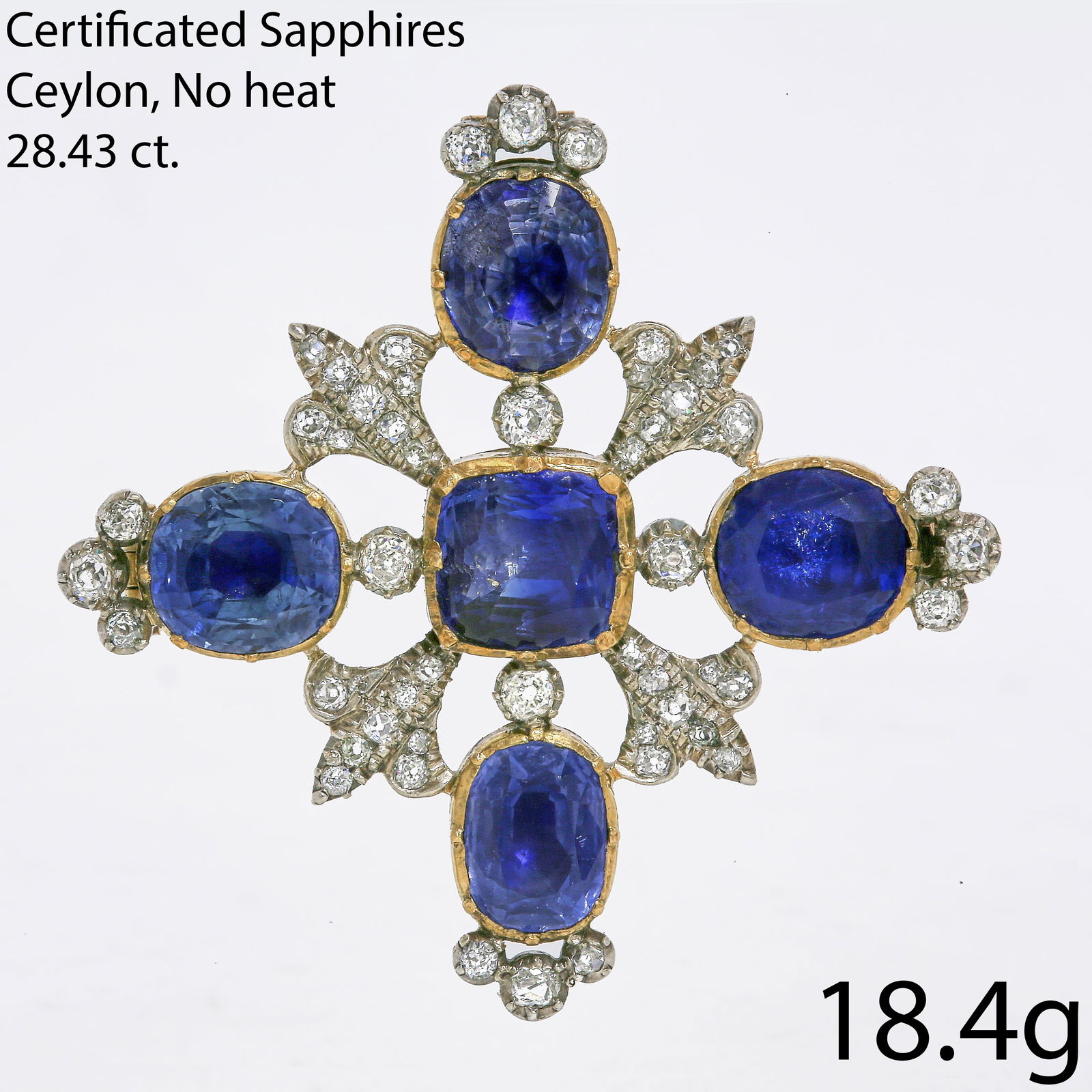 A MAGNIFICENT CERTIFICATED CEYLON NO HEAT VICTORIAN SAPPHIRE AND DIAMOND BROOCH: A MAGNIFICENT CERTIFICATED CEYLON NO HEAT VICTORIAN SAPPHIRE AND DIAMOND BROOCHA magnificent Victorian sapphire and diamond brooch, of cross-shaped design, set with five richly hued cushion-cut sapphi