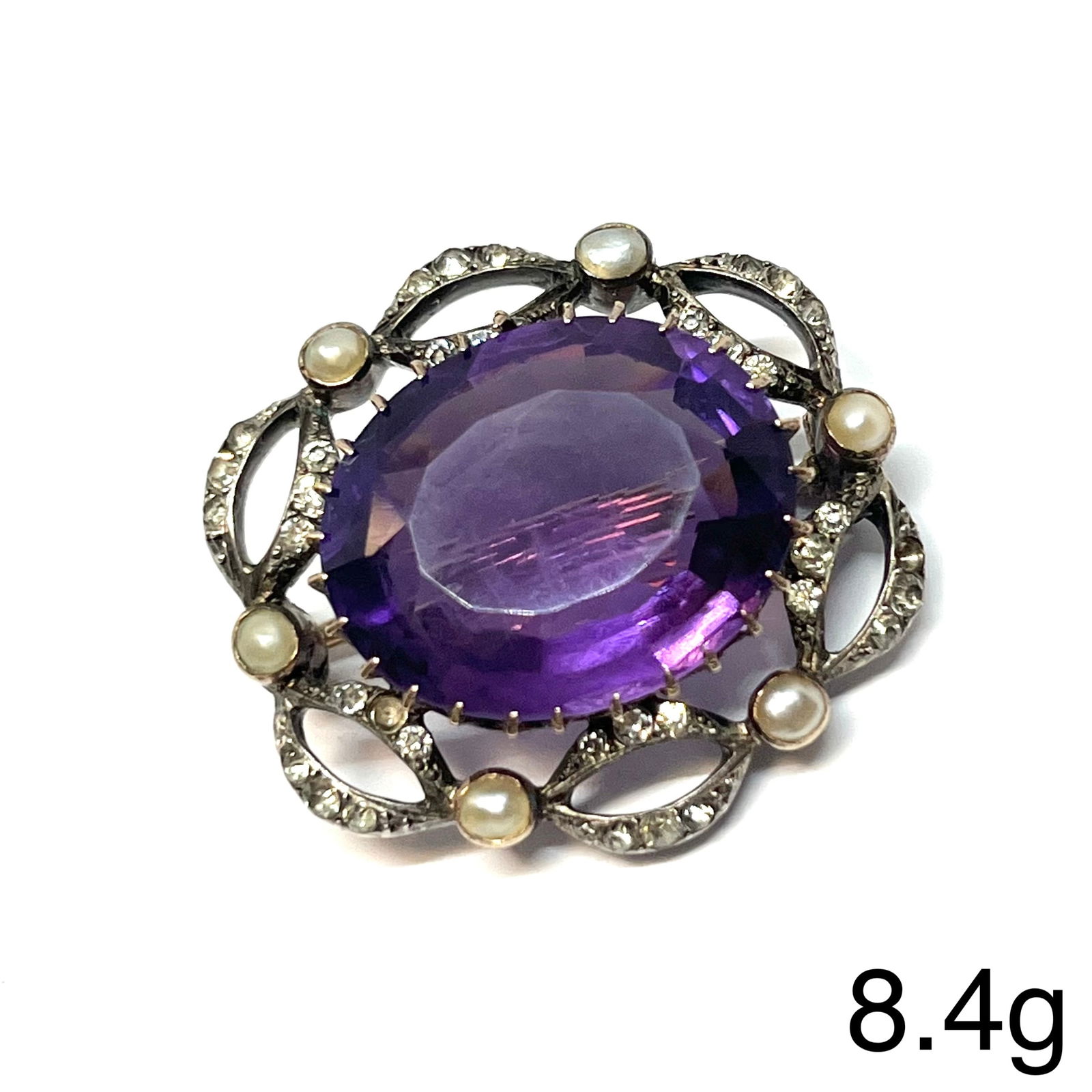VICTORIAN AMETHYST AND PEARL GOLD BROOCH: VICTORIAN AMETHYST AND PEARL GOLD BROOCH,8.2 grams. 9 ct. gold backed.Vibrant amethyst.Pearls untested, assumed to be natural.W. 2.9 cm.