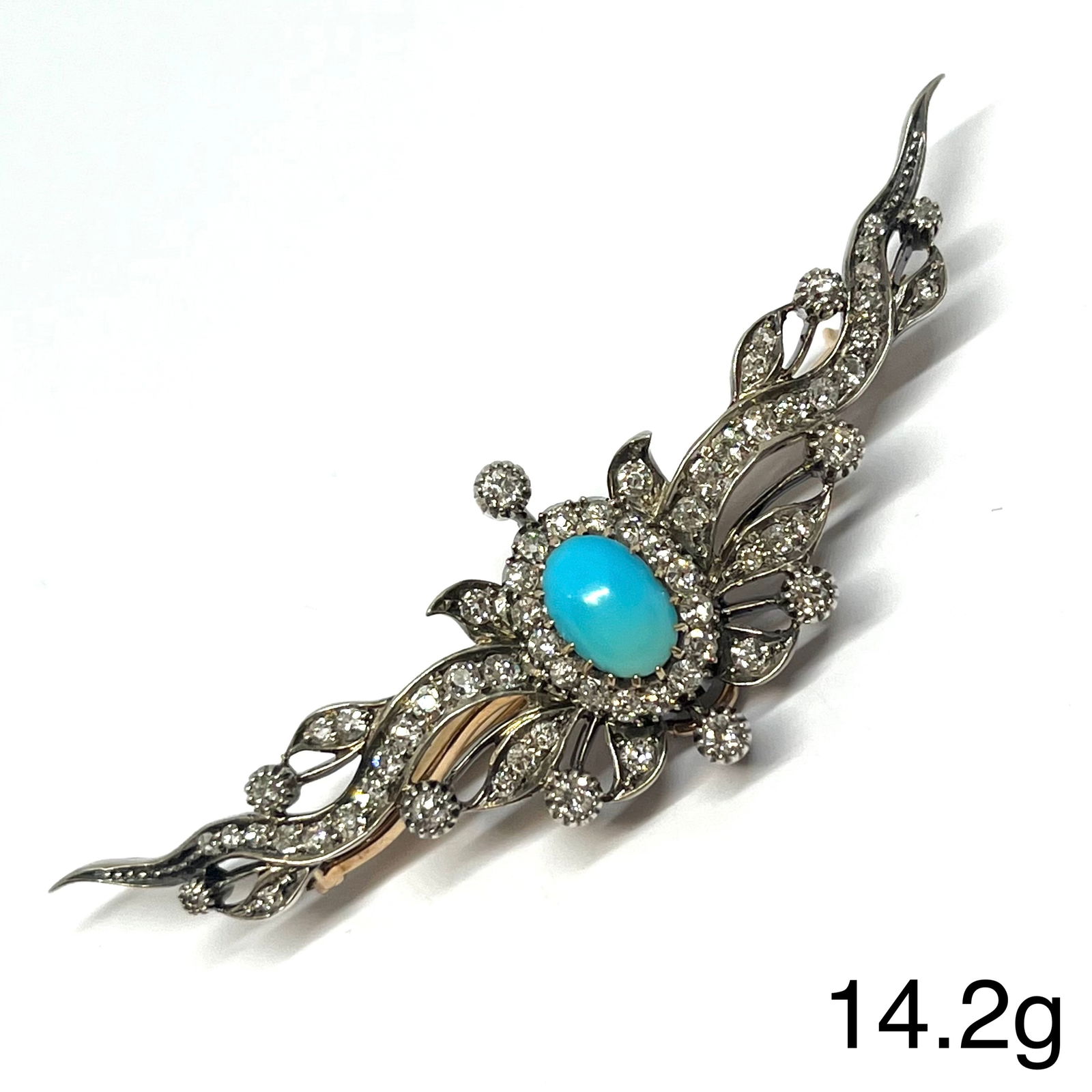 UNUSUAL ANTIQUE TURQUOISE AND DIAMOND BROOCH: UNUSUAL ANTIQUE TURQUOISE AND DIAMOND BROOCH,14.2 grams, testing high carat gold and silver.The brooch of part crescent and sunray design.Vibrant turquoise to the centre.Bright and lively old cut diam