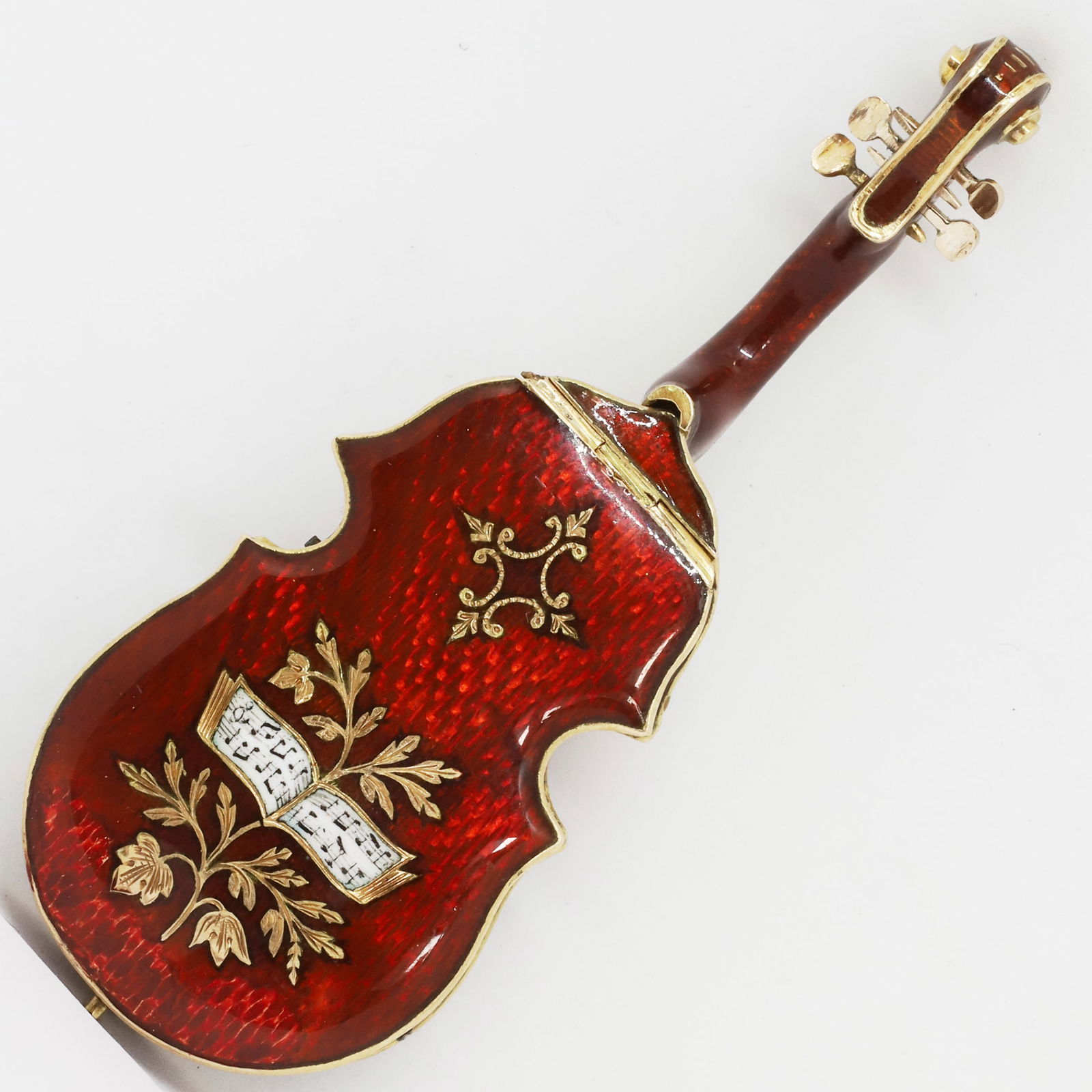 RARE AND UNUSUAL ANTIQUE AUSTRIAN ENAMEL VIOLIN HIDDEN WATCH AND VINAIGRETTE: RARE AND UNUSUAL ANTIQUE AUSTRIAN ENAMEL VIOLIN HIDDEN WATCH AND VINAIGRETTE,25.5 grams, testing high carat gold.The violin decorated with red enamel.The back of the violin can open to reveal the hidd