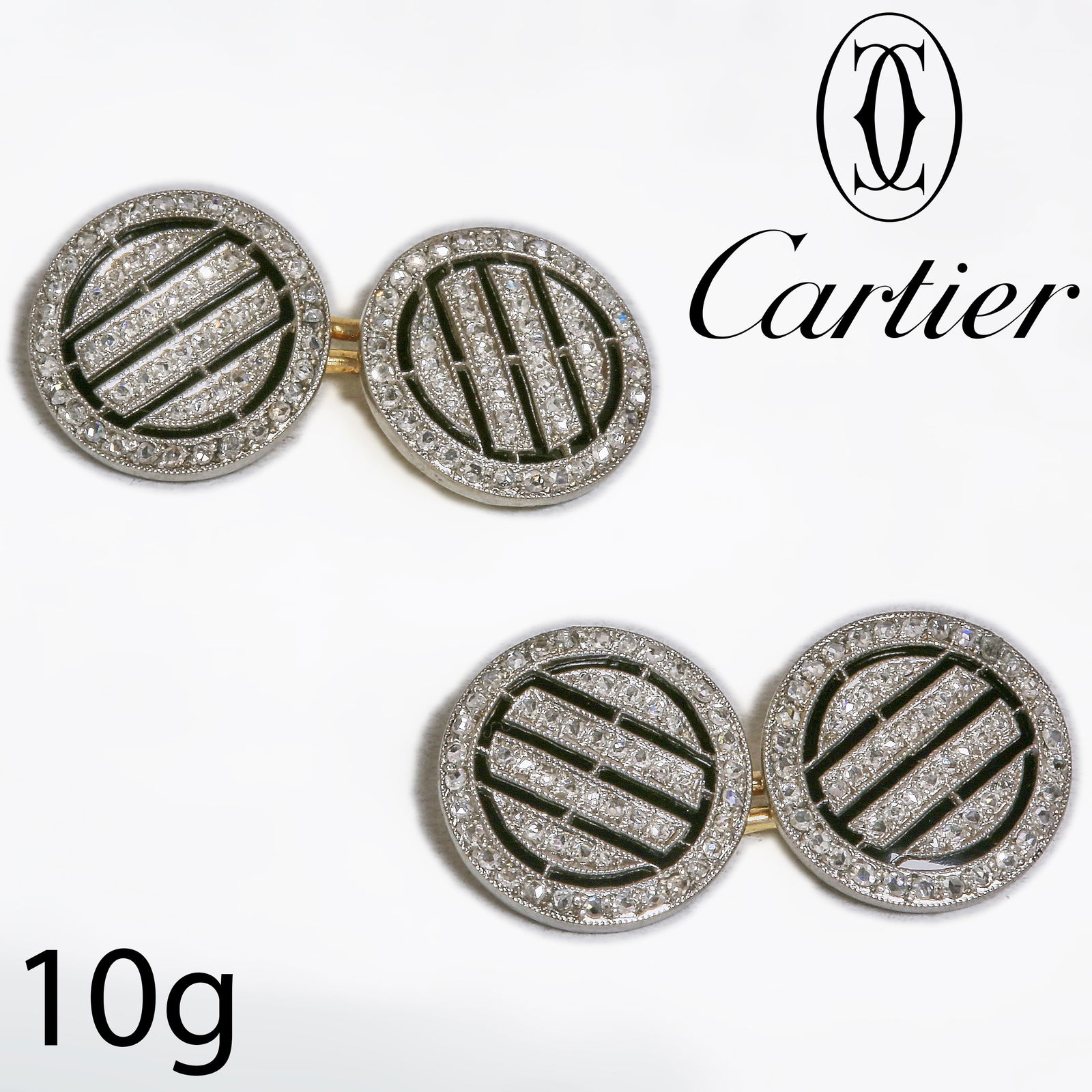 CARTIER, PAIR OF ONYX AND DIAMOND CUFFLINKS: CARTIER, PAIR OF ONYX AND DIAMOND CUFFLINKS,10 grams, 18 ct. gold and platinum.Fine intricate design.Diamond set on an onyx background.Indistinct signed Cartier, numbered.With unrelated cartier