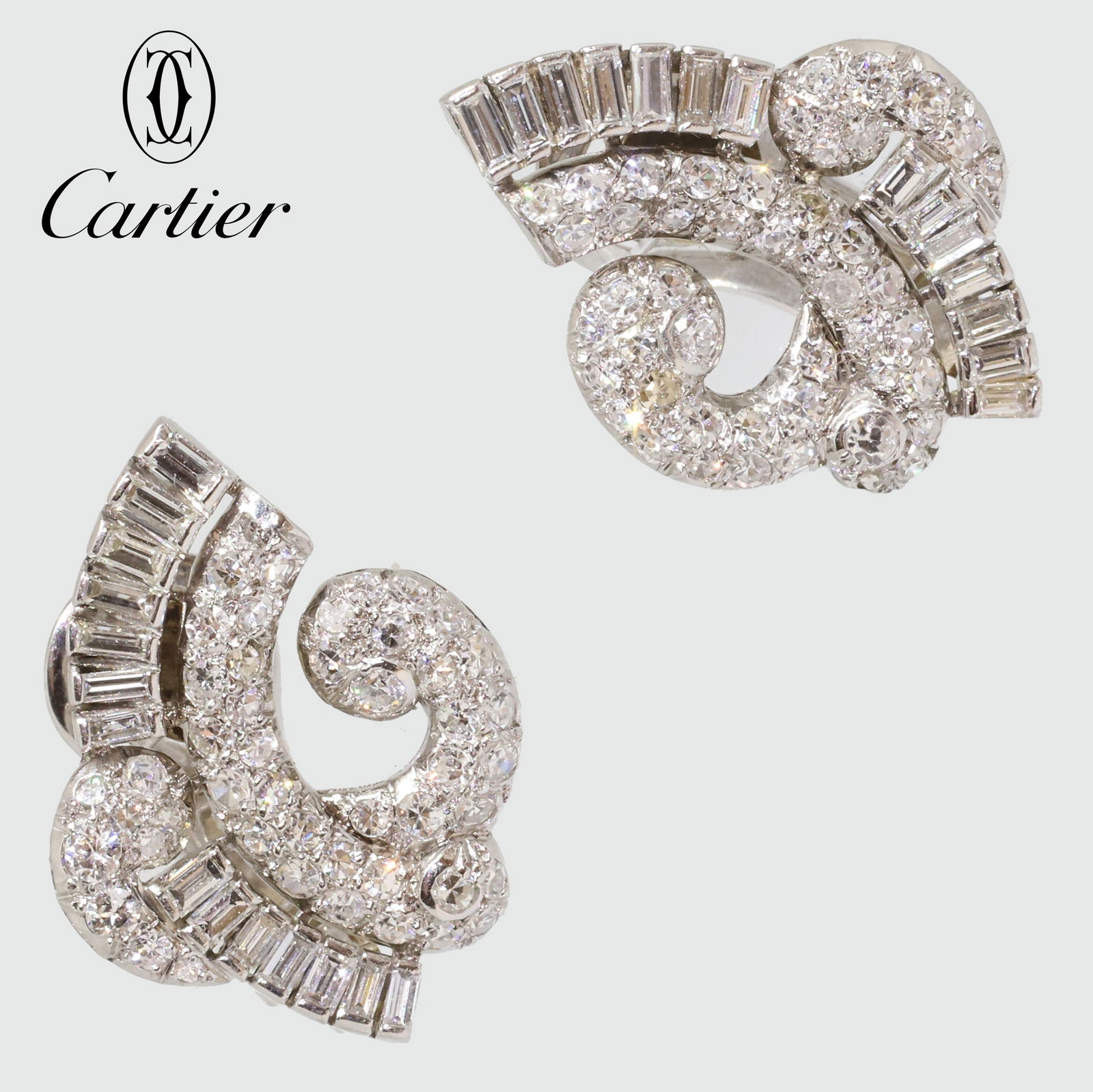 CARTIER PARIS, PAIR OF FANTASTIC ART-DECO DIAMOND EARRINGS: CARTIER PARIS, PAIR OF FANTASTIC ART-DECO DIAMOND EARRINGS,11.9 grams, 18 ct. gold and platinum (French marked).The earrings of refined swirl design.Diamonds bright and lively, totalling approx. 2.50