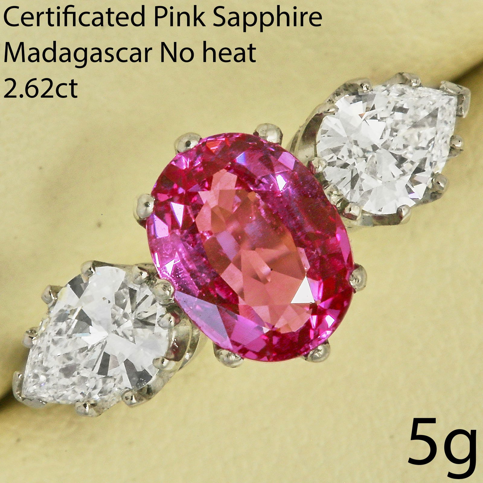 FINE CERTIFICATED PINK SAPPHIRE AND DIAMOND RING: FINE CERTIFICATED PINK SAPPHIRE AND DIAMOND RING,5 grams, platinum.Fine pink sapphire with great clarity, of approx. 2.62 ct. (Certificated, Madagascar origin, No indications of Heating).On each side