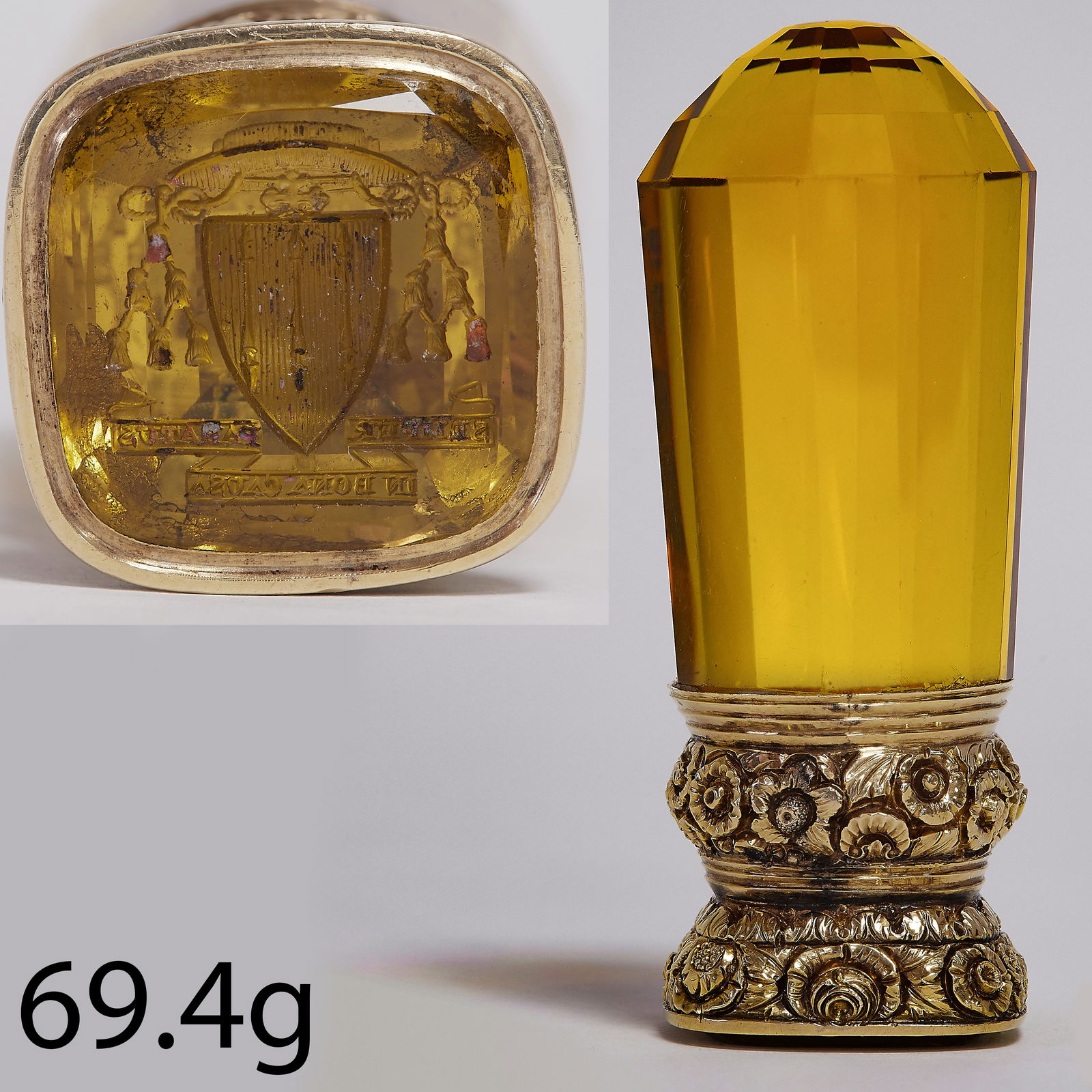 RARE GEORGIAN CITRINE DESK SEAL: RARE GEORGIAN CITRINE DESK SEAL,69.4 grams. Testing high carat gold.The gold mount with fine floral relief decoration.The handle of a single piece of citrine of approx. 42 x 24.6 x 24.8 mm. (light tap