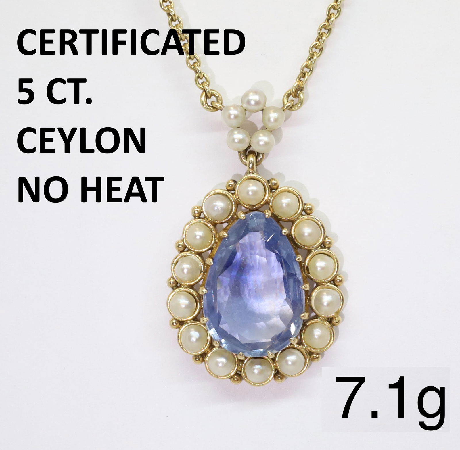 CERTIFICATED CEYLON NO HEAT SAPPHIRE AND PEARL PENDANT NECKLACE: CERTIFICATED CEYLON NO HEAT SAPPHIRE AND PEARL PENDANT NECKLACE7.1 grams, high carat gold chain and mount.The central sapphire of approximately 5 ct, accompanied by GCS certificate stating the sapphir