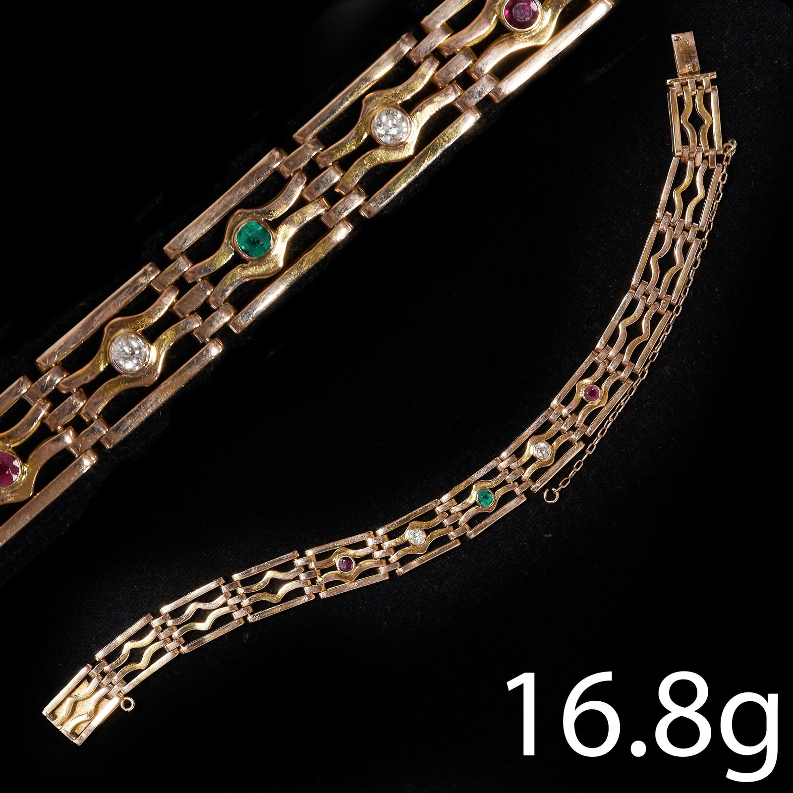 VINTAGE DIAMOND, RUBY AND EMERALD GATE LINK BRACELET: VINTAGE DIAMOND, RUBY AND EMERALD GATE LINK BRACELET 16.9 grams, testing 15 ct. gold. Vibrant rubies, emerald and diamonds.L 19 cm