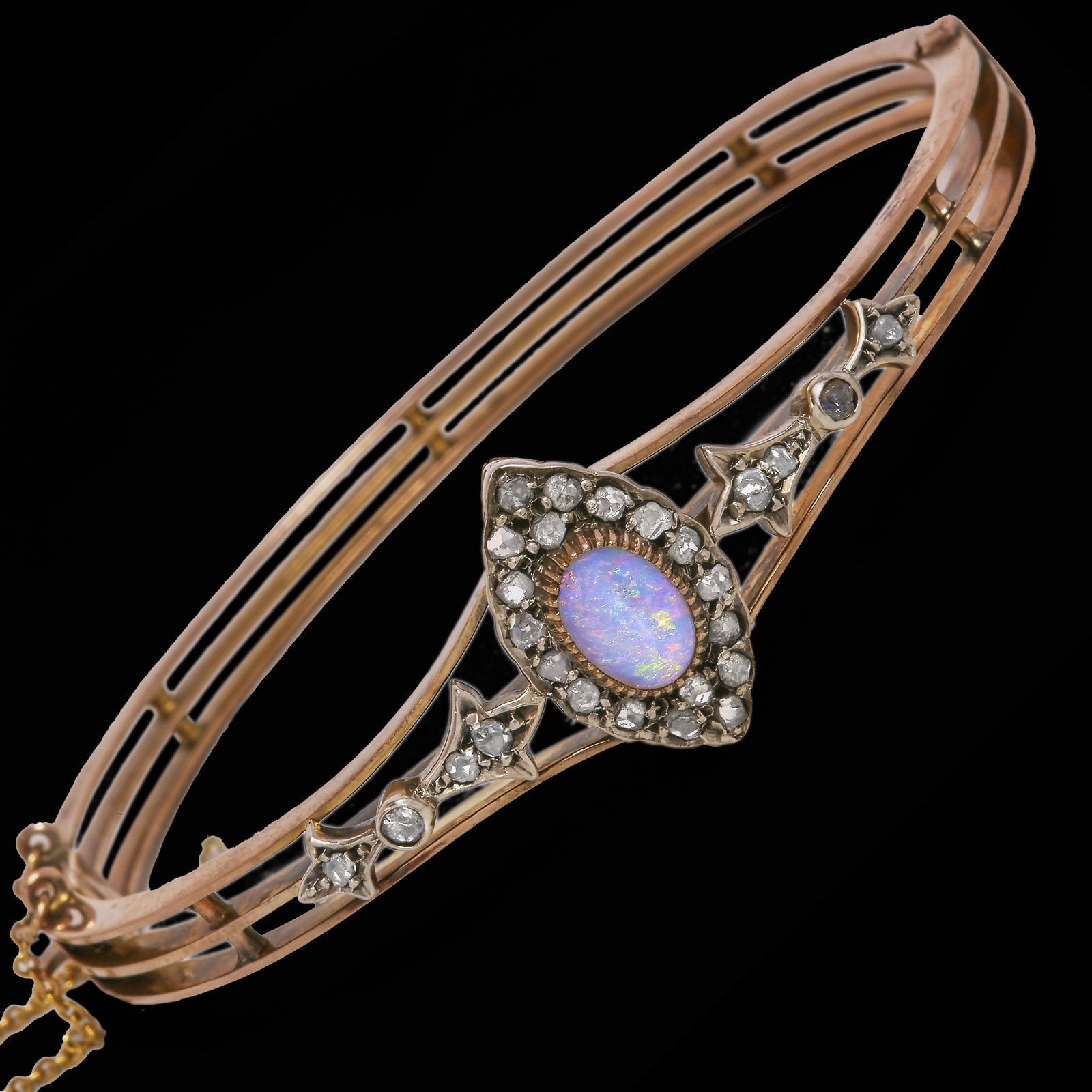 ANTIQUE OPAL AND DIAMOND HINGED GOLD BANGLE: ANTIQUE OPAL AND DIAMOND HINGED GOLD BANGLE 11.9 grams vibrant opal with great play of colour, including redslively diamonds 5.8 cm inner diameter