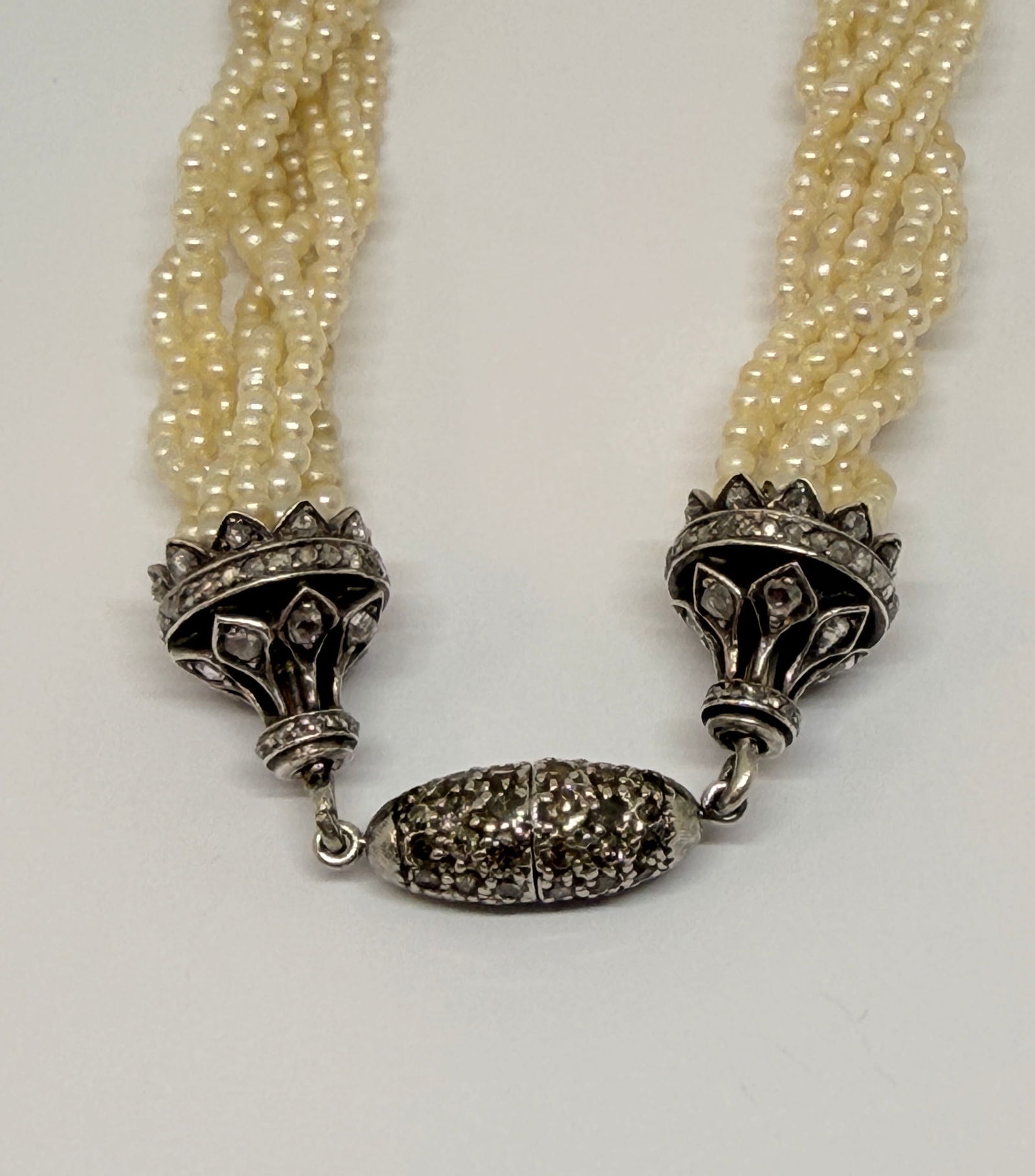 EDWARDIAN MULTI STRAND PEARL NECKLACE: EDWARDIAN MULTI STRAND PEARL NECKLACE,22,6 grams.Diamond set clasp.Pearls generally well matched.L. 41 cm.