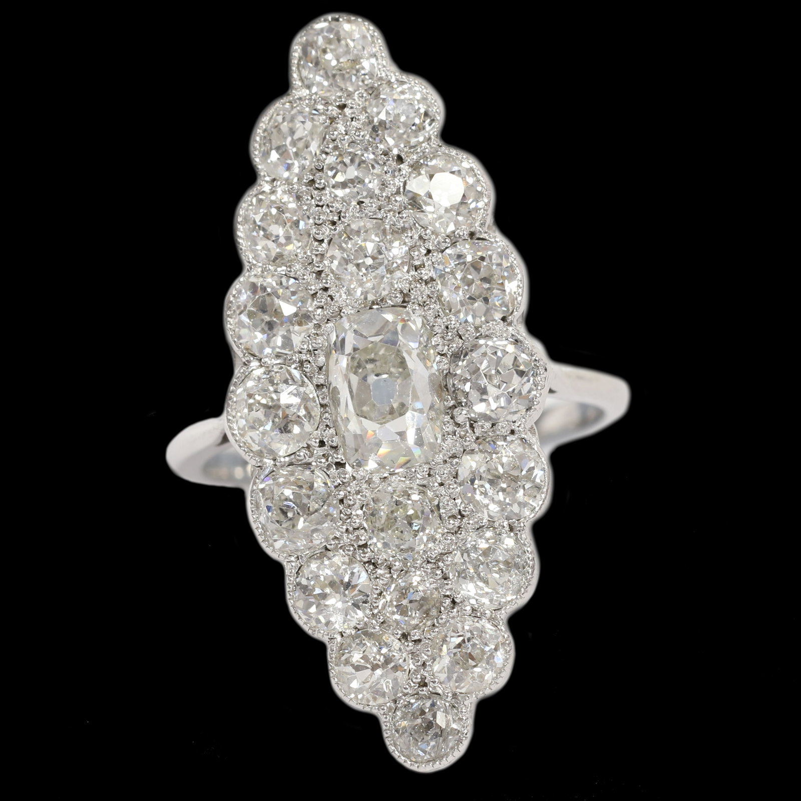 EDWARDIAN DIAMOND MARQUISE SHAPED RING: EDWARDIAN DIAMOND MARQUISE SHAPED RING,5.6 grams, testing platinum.Bright and lively old cut diamonds.Larger centre diamond of approx. 1.12 ct.Diamonds totalling approx. 5.20 ct.L. head 3.2 cm.Size O.