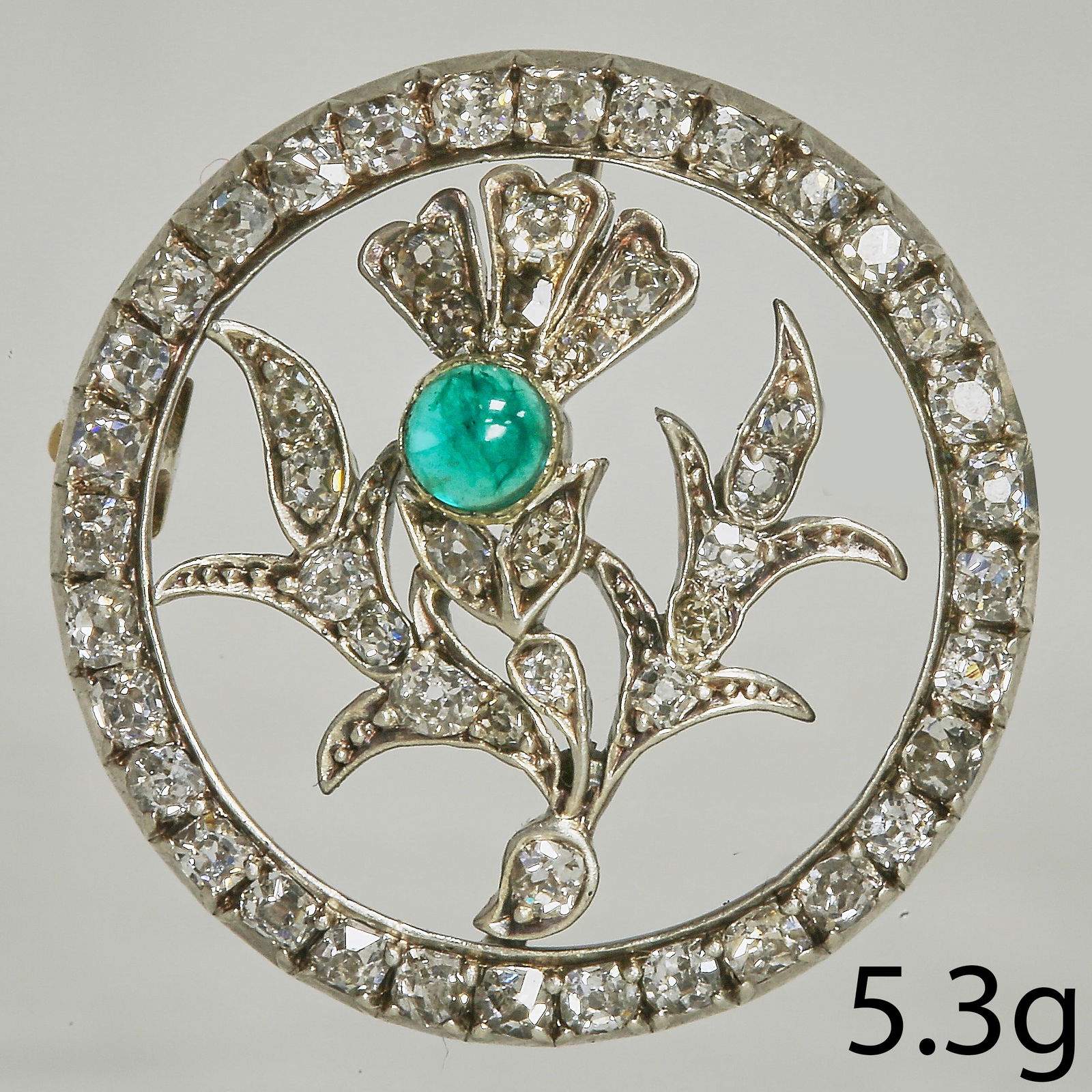 VICTORIAN DIAMOND THISTLE FLORAL BROOCH: VICTORIAN DIAMOND THISTLE FLORAL BROOCH 5.3 grams Bright and lively old cut diamonds, totalling approx. 1.20 ct.lovely emerald.fine craftsmanship in great condition 2.2 cm diameter