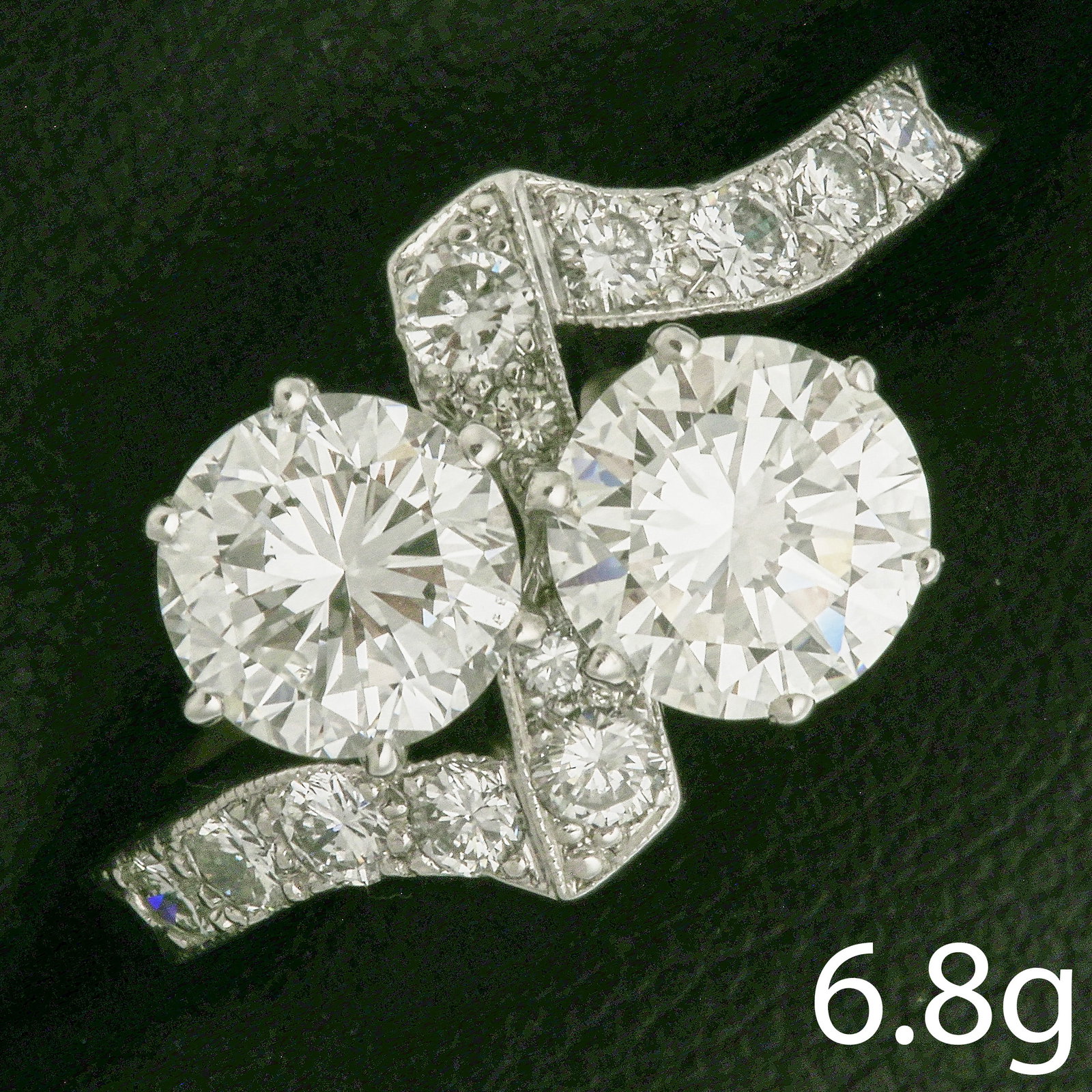 FINE TOI-ET-MOI DIAMOND TWIST RING: FINE TOI-ET-MOI DIAMOND TWIST RING,6 grams, testing platinum.Principal diamonds of approx. 1.14 and 1.13 ct.In our opinion F-G colour, VS clarity.Size Q 1/2.