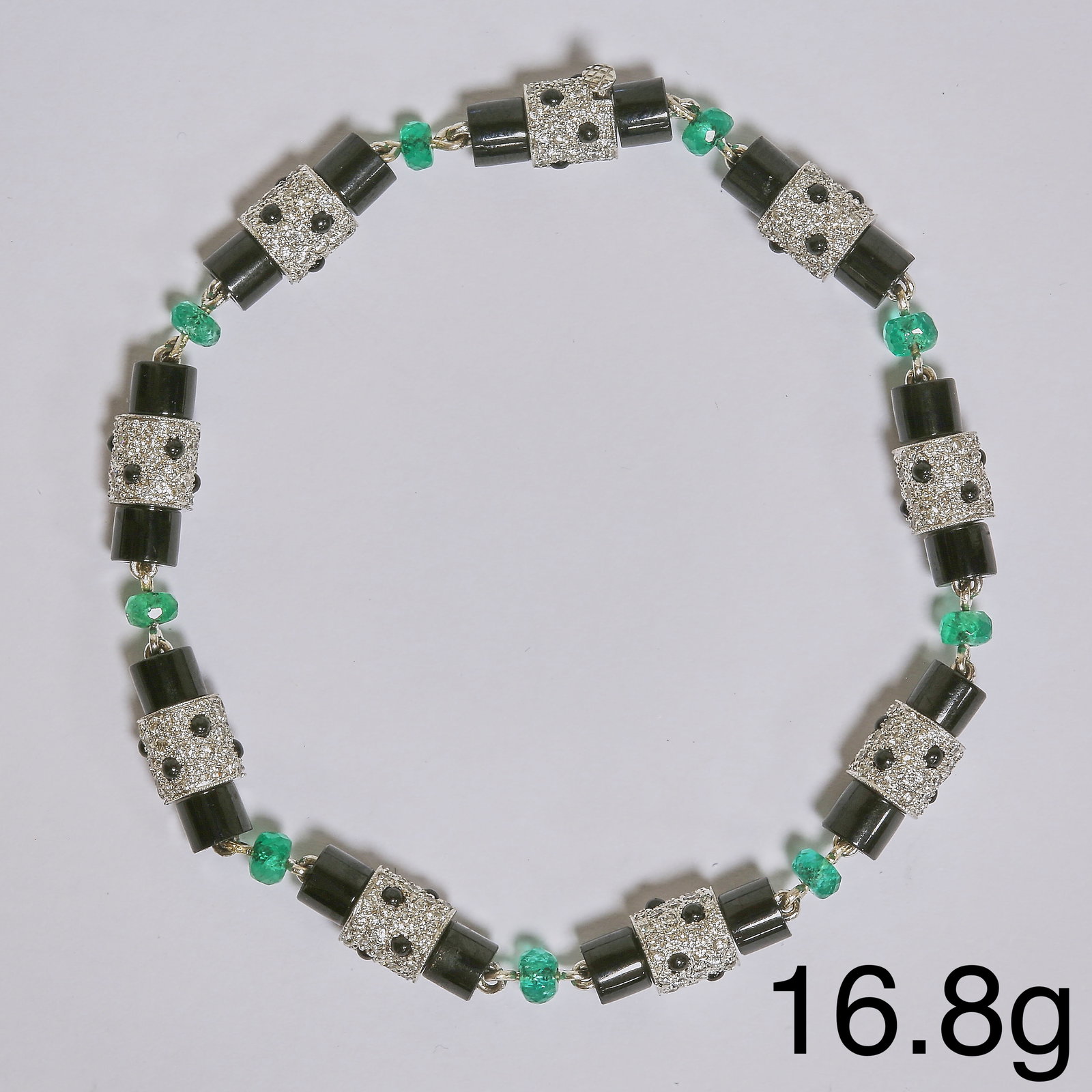 FINE ART-DECO EMERALD, DIAMOND AND ONYX BRACELET: FINE ART-DECO EMERALD, DIAMOND AND ONYX BRACELET16.8 grams high carat gold vibrant emeralds bright lively diamonds in excellent condition fine craftsmanship L 19 cm