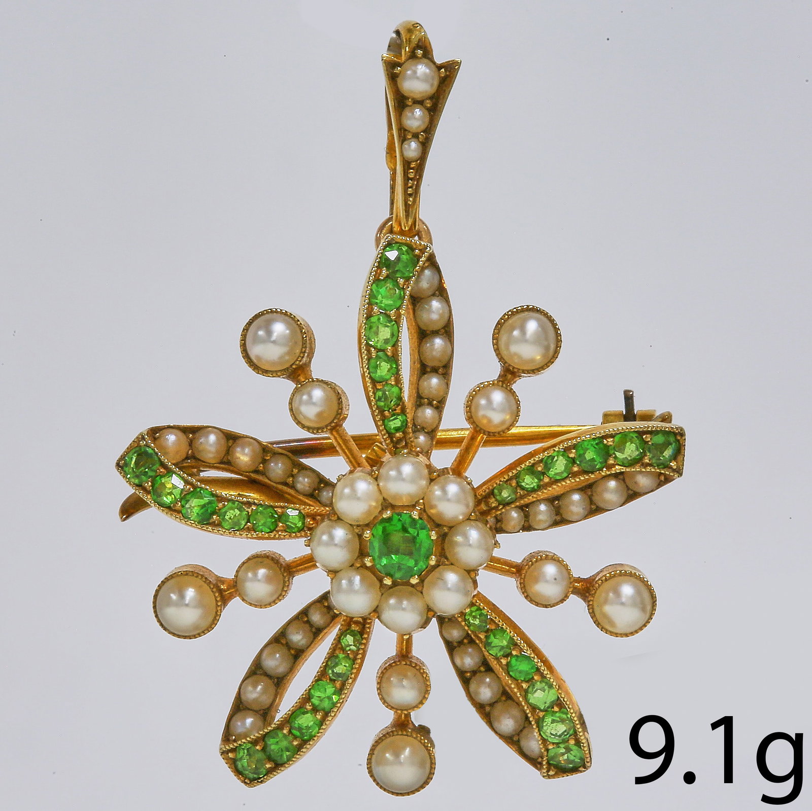 VICTORIAN DEMANTOID GARNET AND PEARL BROOCH/PENDANT: VICTORIAN DEMANTOID GARNET AND PEARL BROOCH/PENDANT,9.1 grams, 15 ct. gold.Vibrant demantoid garnets.Lovely pearls, well matched (untested, believed to be natural).L. 4 cm.Removable brooch fitting.
