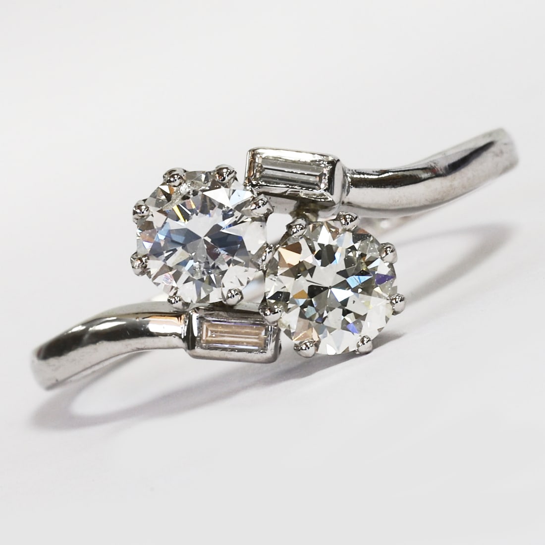 DIAMOND TOI-ET-MOI TWIST RING: DIAMOND TOI-ET-MOI TWIST RING,3.7 grams, testing platinum.Bright and lively diamonds, totalling approx. 0.80 ct.Size N.