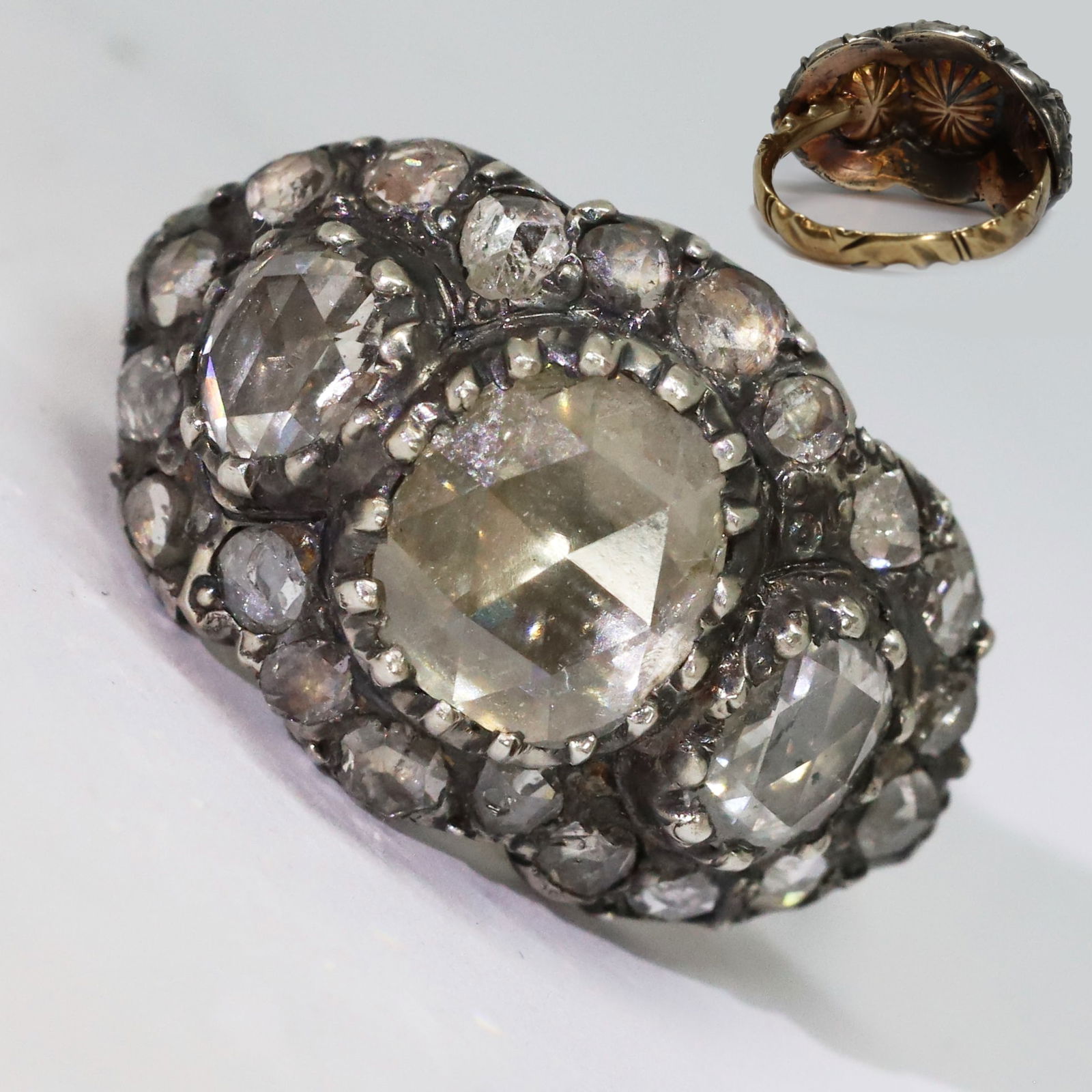 ANTIQUE DIAMOND CLUSTER RING: ANTIQUE DIAMOND CLUSTER RING,8.2 grams.Large rose cut diamond to the centre, of approx. 8,4 x 7,7 mm.L. head 2,3 cm.Size O 1/2.
