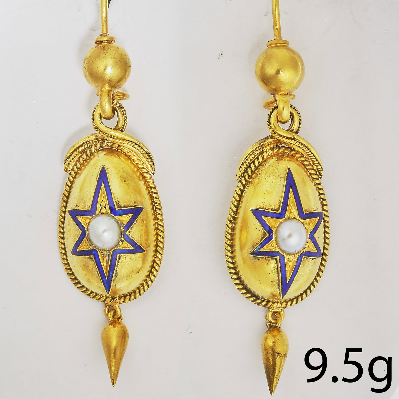 PAIR OF VICTORIAN ENAMEL AND PEARL EARRINGS: PAIR OF VICTORIAN ENAMEL AND PEARL EARRINGS,9.5 grams, testing high carat gold.Lovely blue enamel in star pattern, surrounding the central pearl.Articulated drop.L. 5.5 cm.With antique earring box.