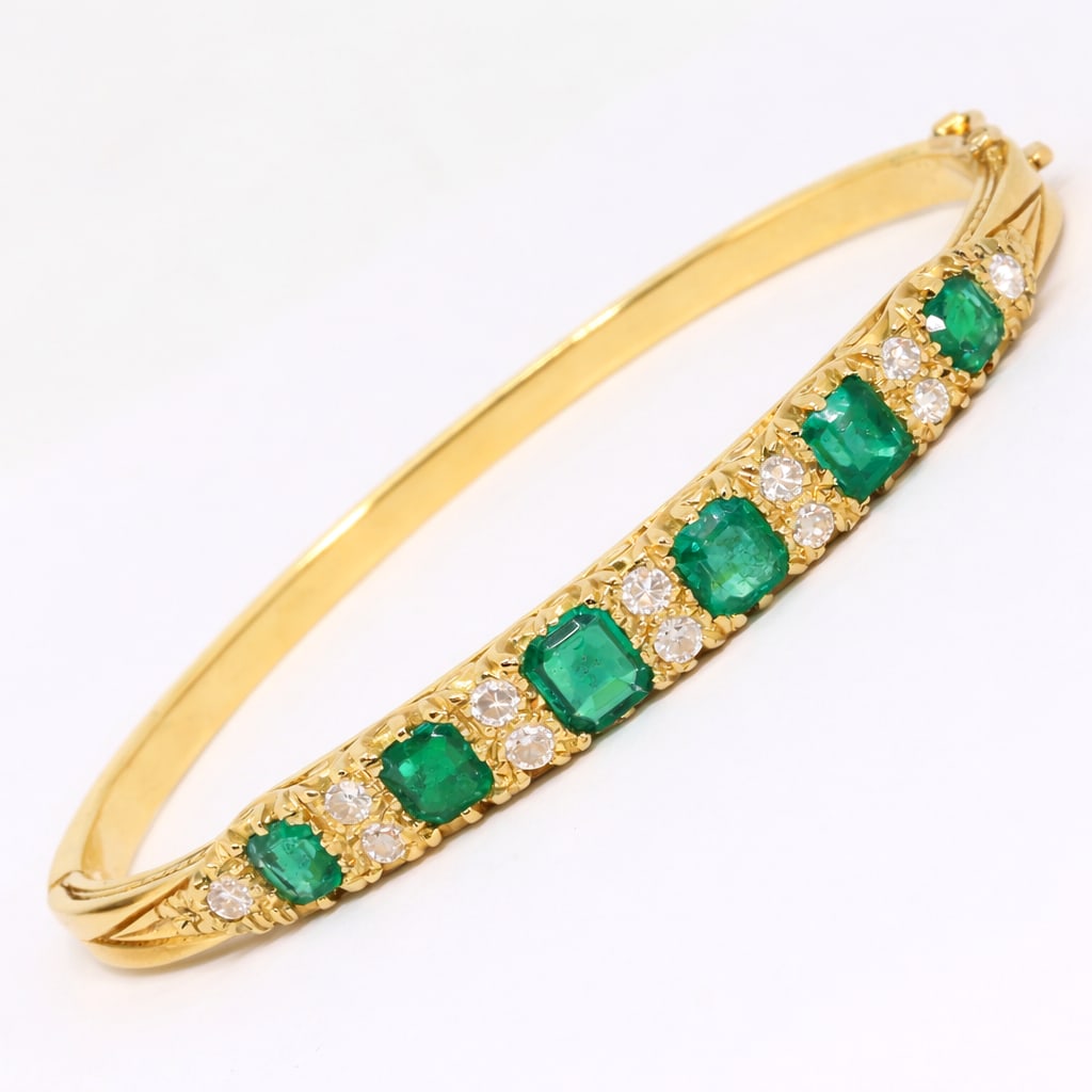 FINE EMERALD AND DIAMOND BANGLE: FINE EMERALD AND DIAMOND BANGLE,21.7 grams, testing high carat gold.Rich and vibrant emeralds, totalling approx. 2.10 ct.Diamonds bright and lively.Inner diam. 5.5 cm.