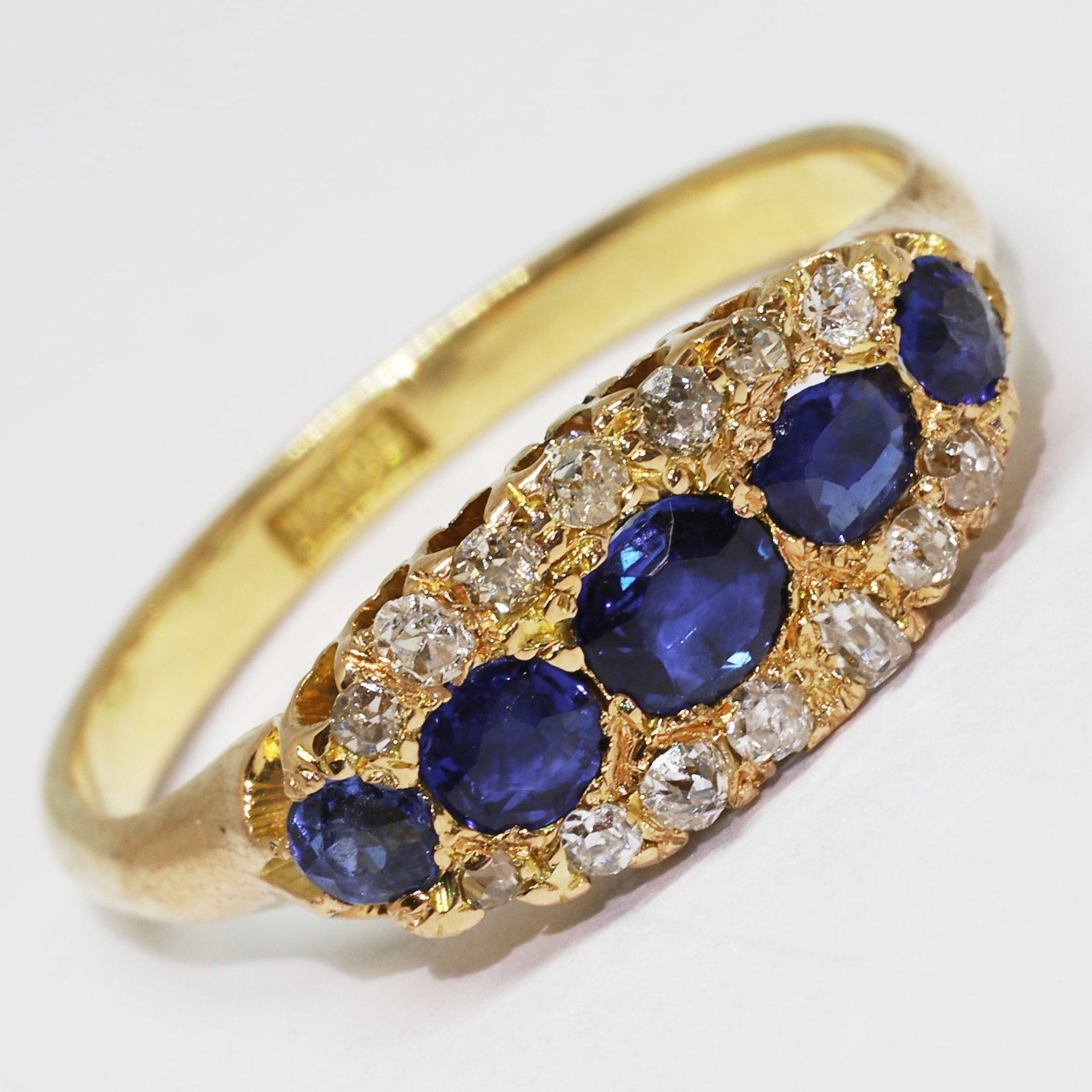 SAPPHIRE AND DIAMOND RING: SAPPHIRE AND DIAMOND RING,18 ct. gold.Rich and vibrant sapphires.Diamonds bright and lively.Size L.