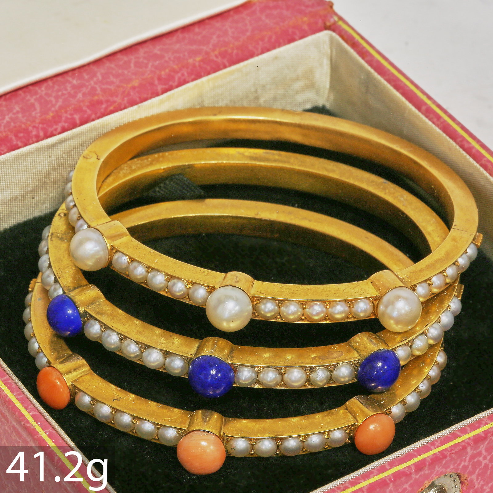 RARE SET OF 3 VICTORIAN BANGLES, PEARL, CORAL AND LAPIS LAZULI: RARE SET OF 3 VICTORIAN BANGLES, PEARL, CORAL AND LAPIS LAZULI,41.2 grams, testing high carat gold.1 bangle set with smaller and larger pearls (largest 6.93 mm.1 bangle with pearls and larger lapis la