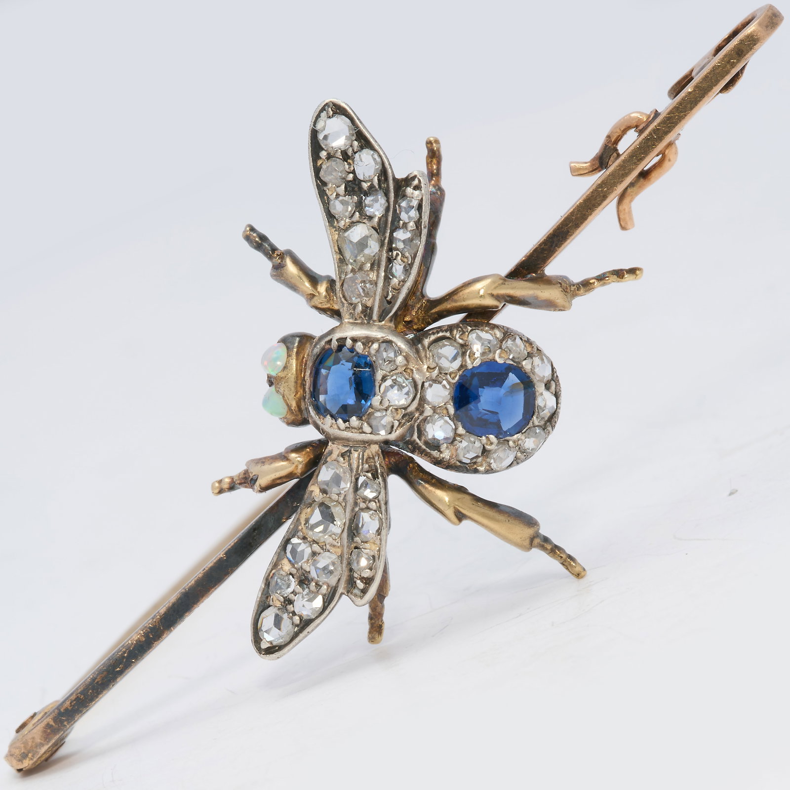 SAPPHIRE AND DIAMOND FLY BROOCH: SAPPHIRE AND DIAMOND FLY BROOCH,4.9 grams, testing high carat gold and silver.Bright and lively diamonds.Rich and vibrant sapphires.Opal eyes.W. 5.1 cm.