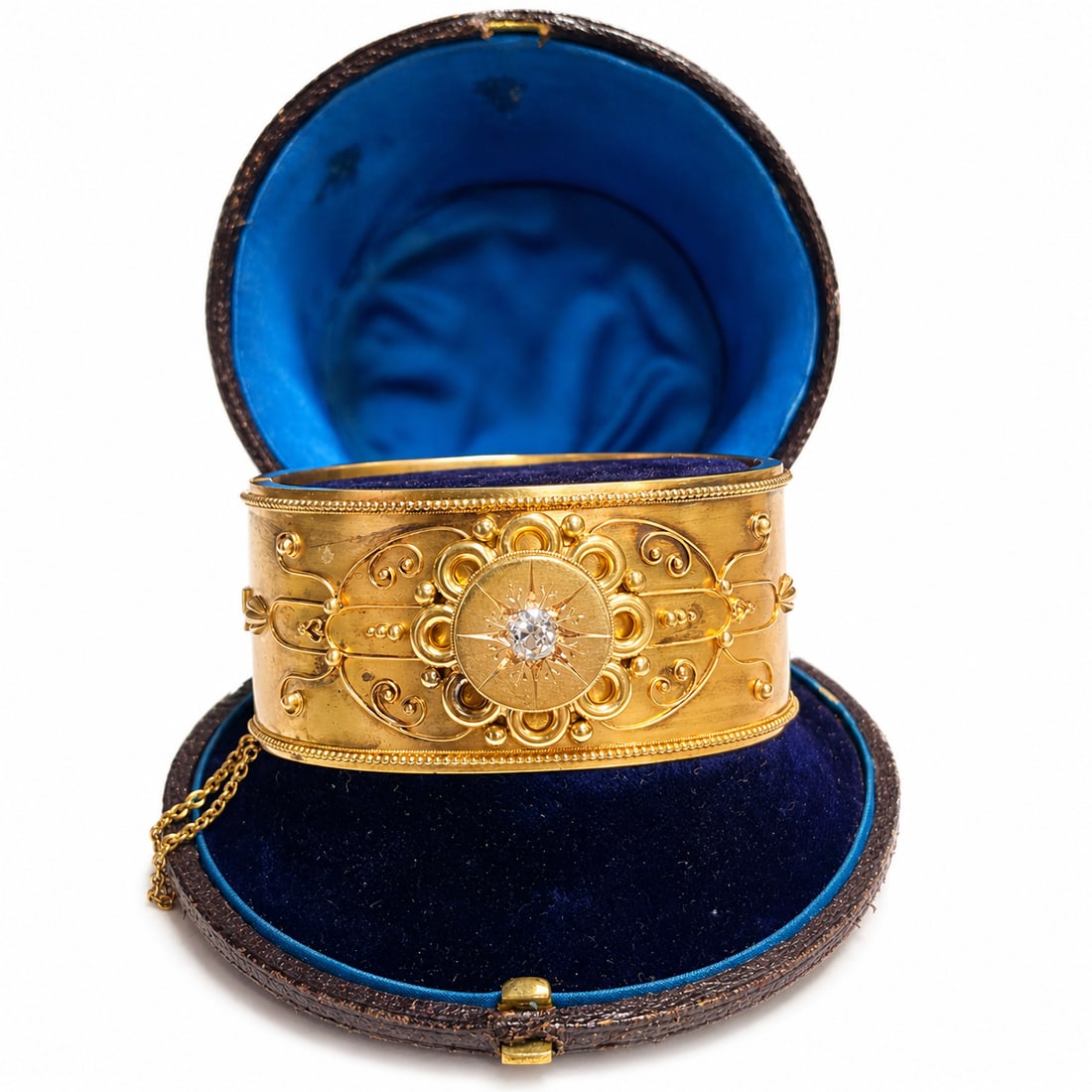 VICTORIAN ETRUSCAN REVIVAL DIAMOND CUFF BANGLE: VICTORIAN ETRUSCAN REVIVAL DIAMOND CUFF BANGLE,44,2 grams, testing high carat gold.The Bangle with lovely relief and applique decoration.Set with a bright and lively old cut diamond to the